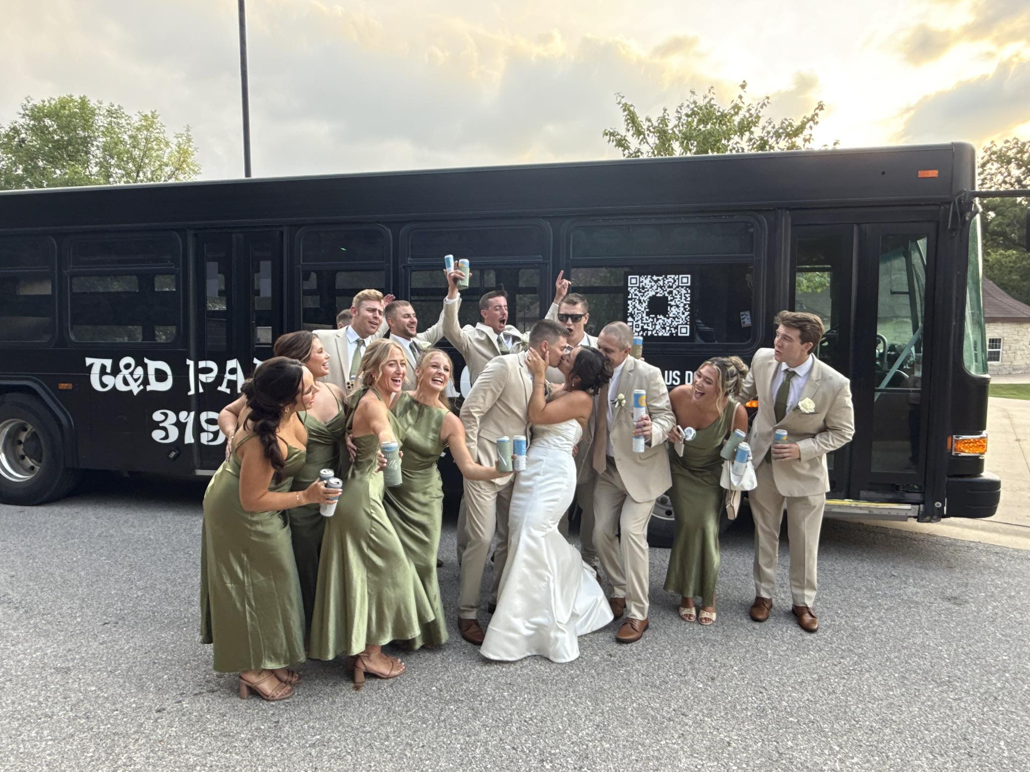 Wedding party group in front of party bus