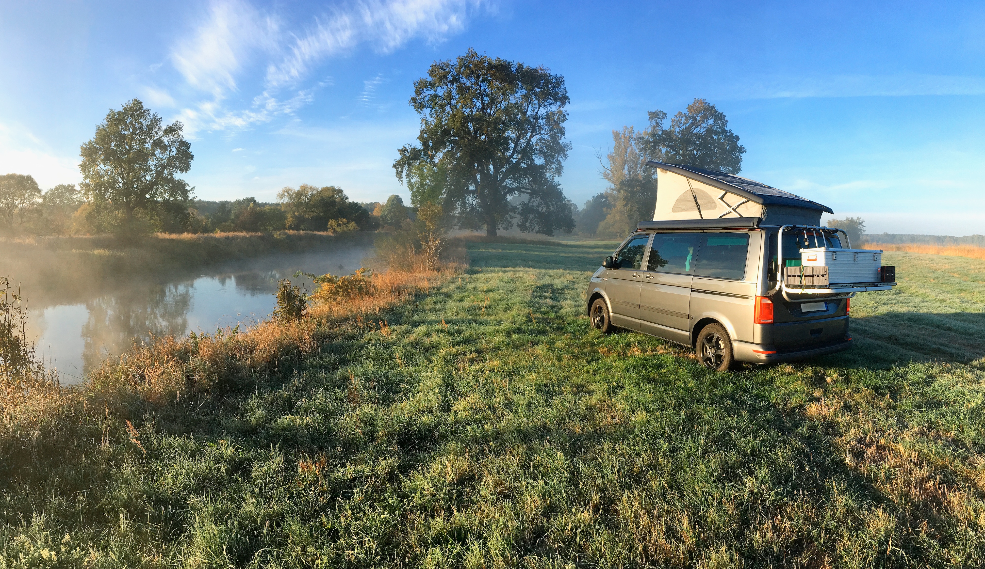 Clean modern campervan parked at a rural location