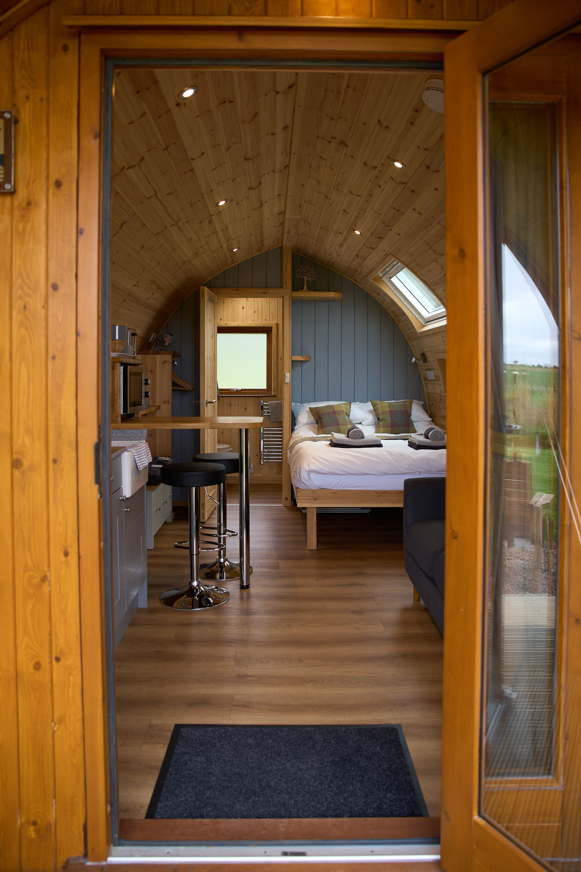 Exterior view of the Juniper Hot Tub Pod surrounded by nature