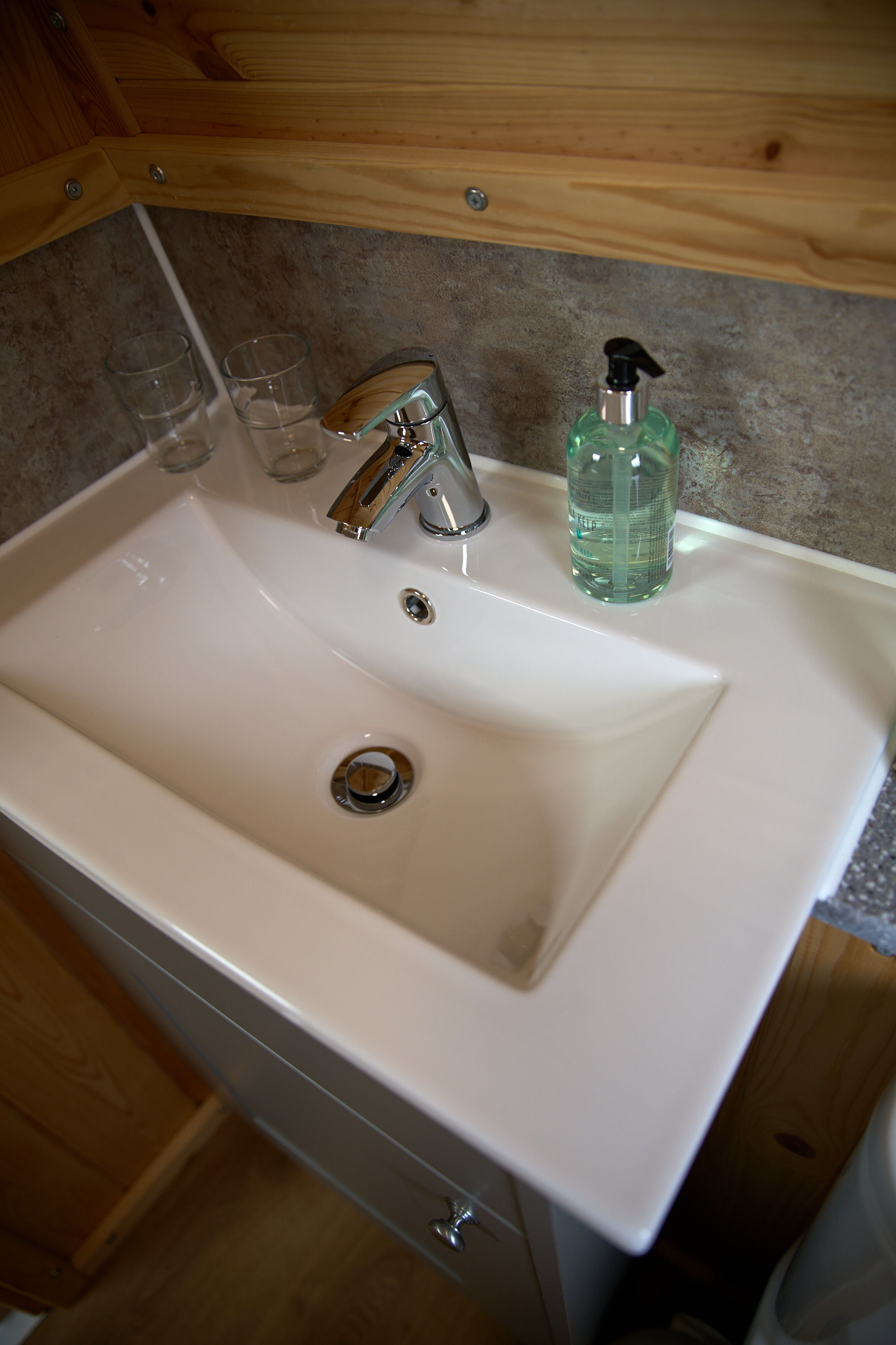 Modern en-suite bathroom sink and luxury toiletries in the glamping pod