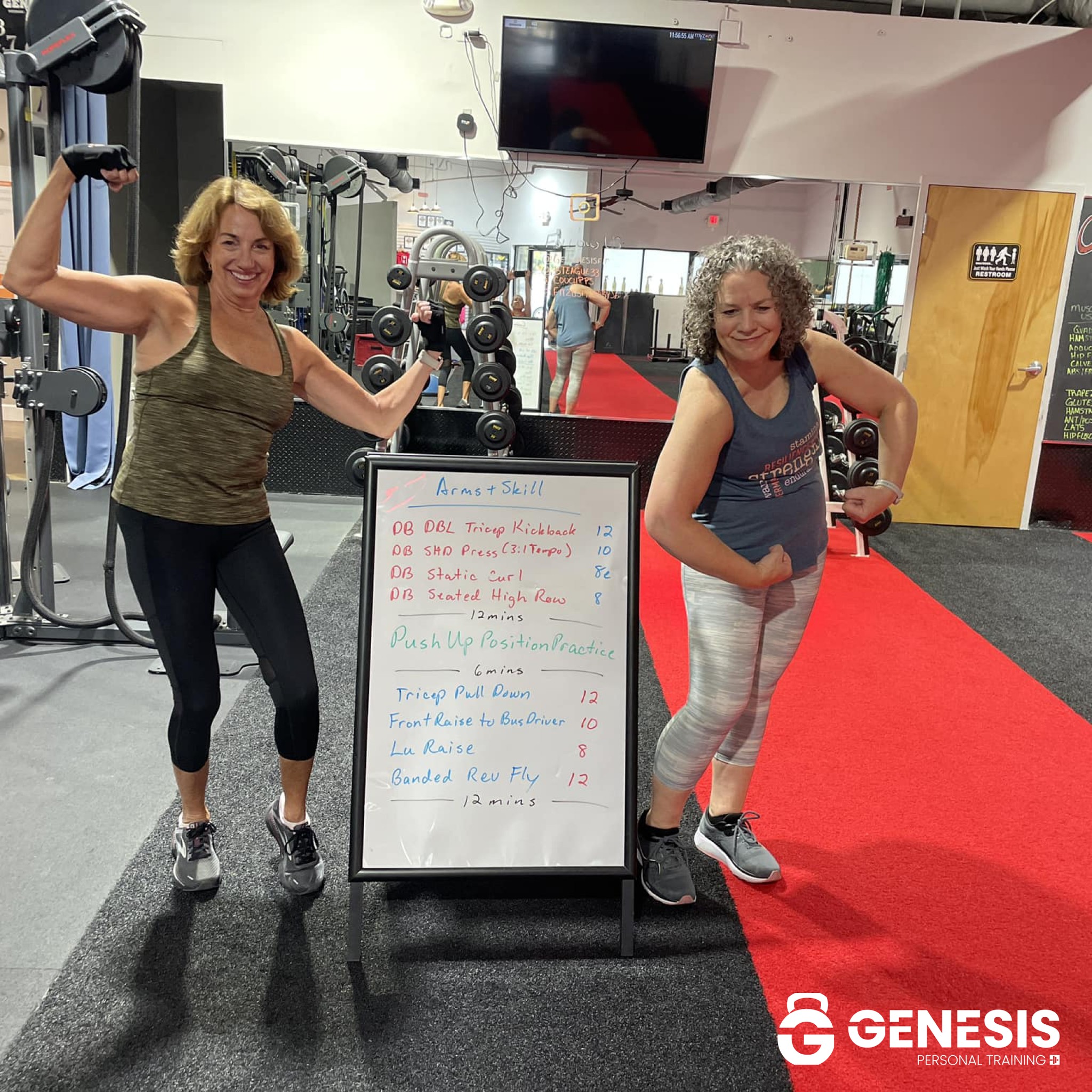 Genesis Member Spotlight — Two women flexing at the whiteboard