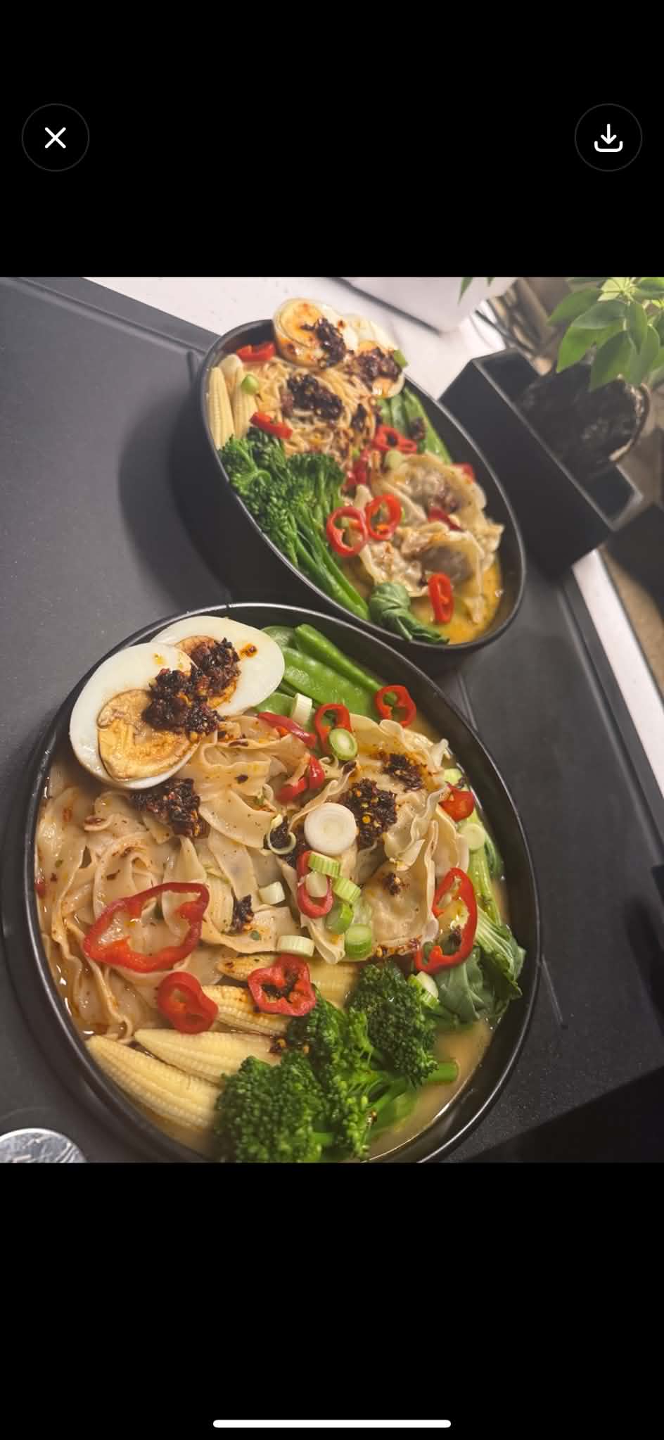 Noodle bowl with dumplings and soft boiled egg