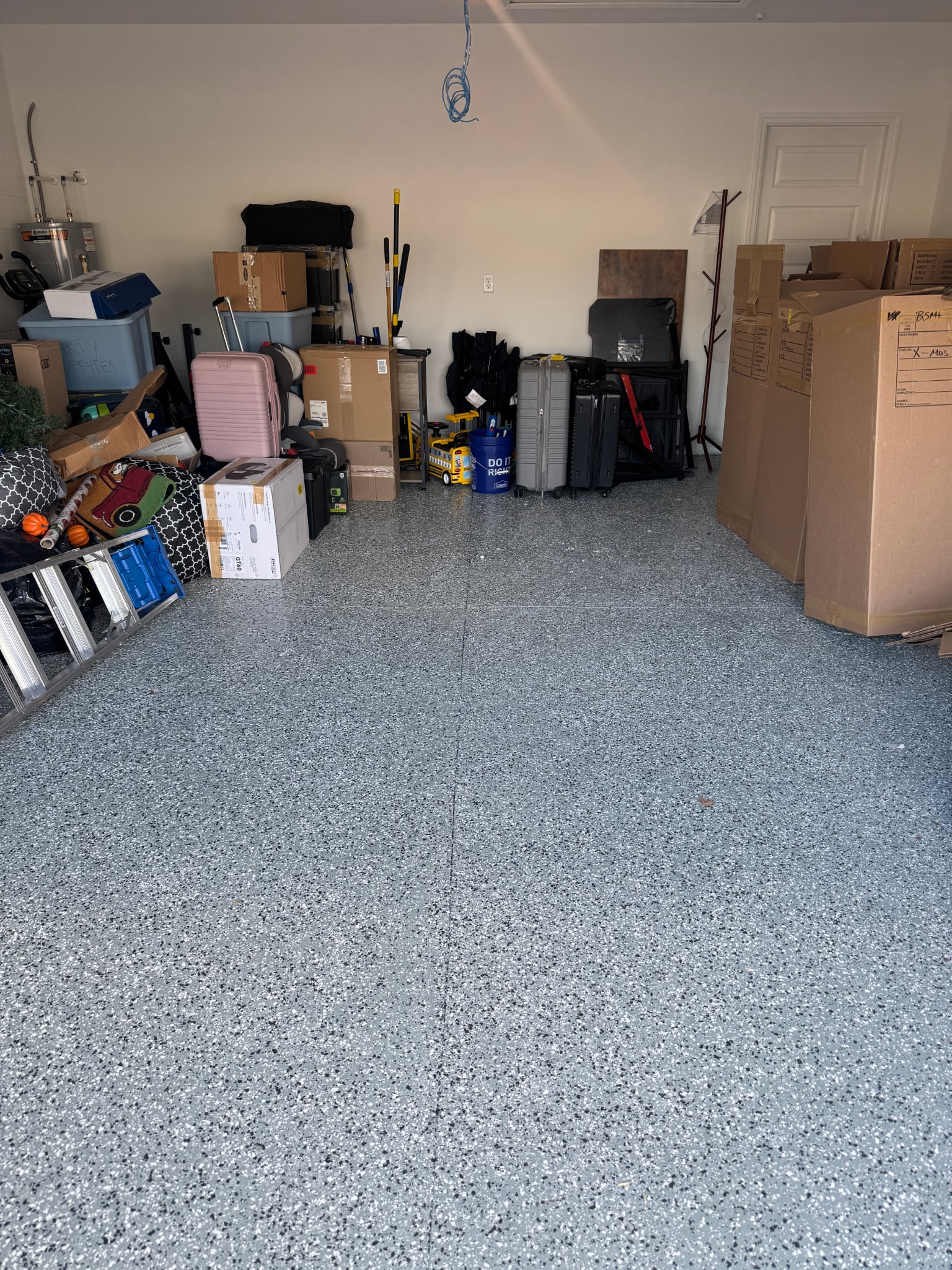 Clean epoxy garage floor with boxes neatly staged