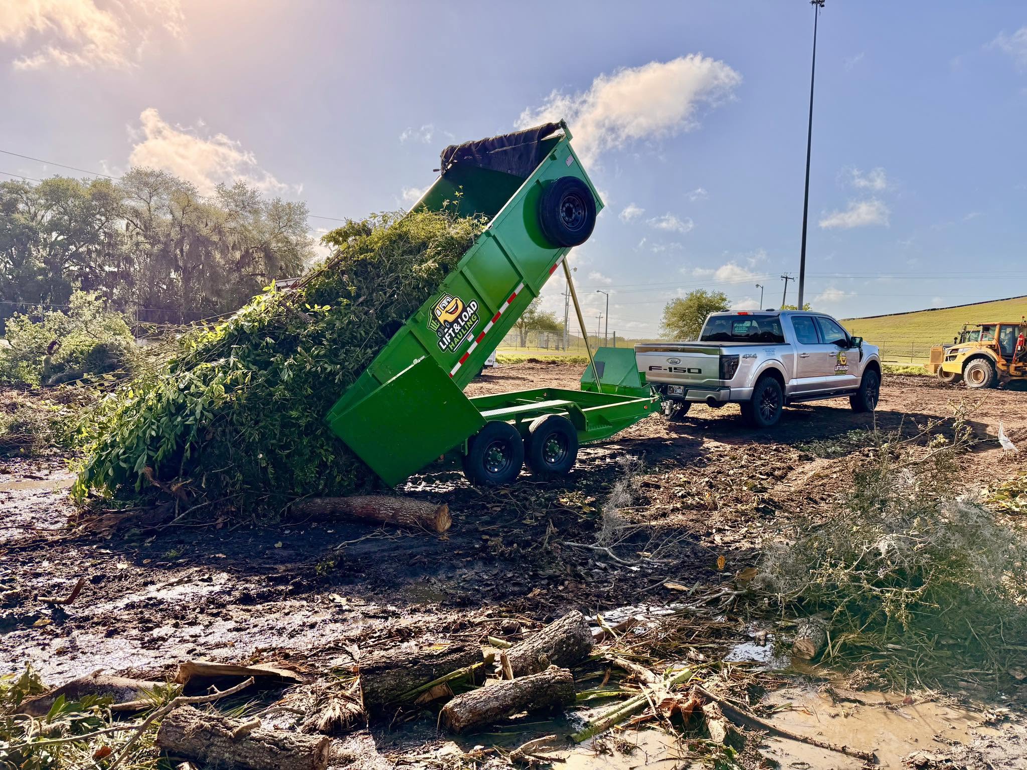 Lift & Load Hauling truck dumping yard waste