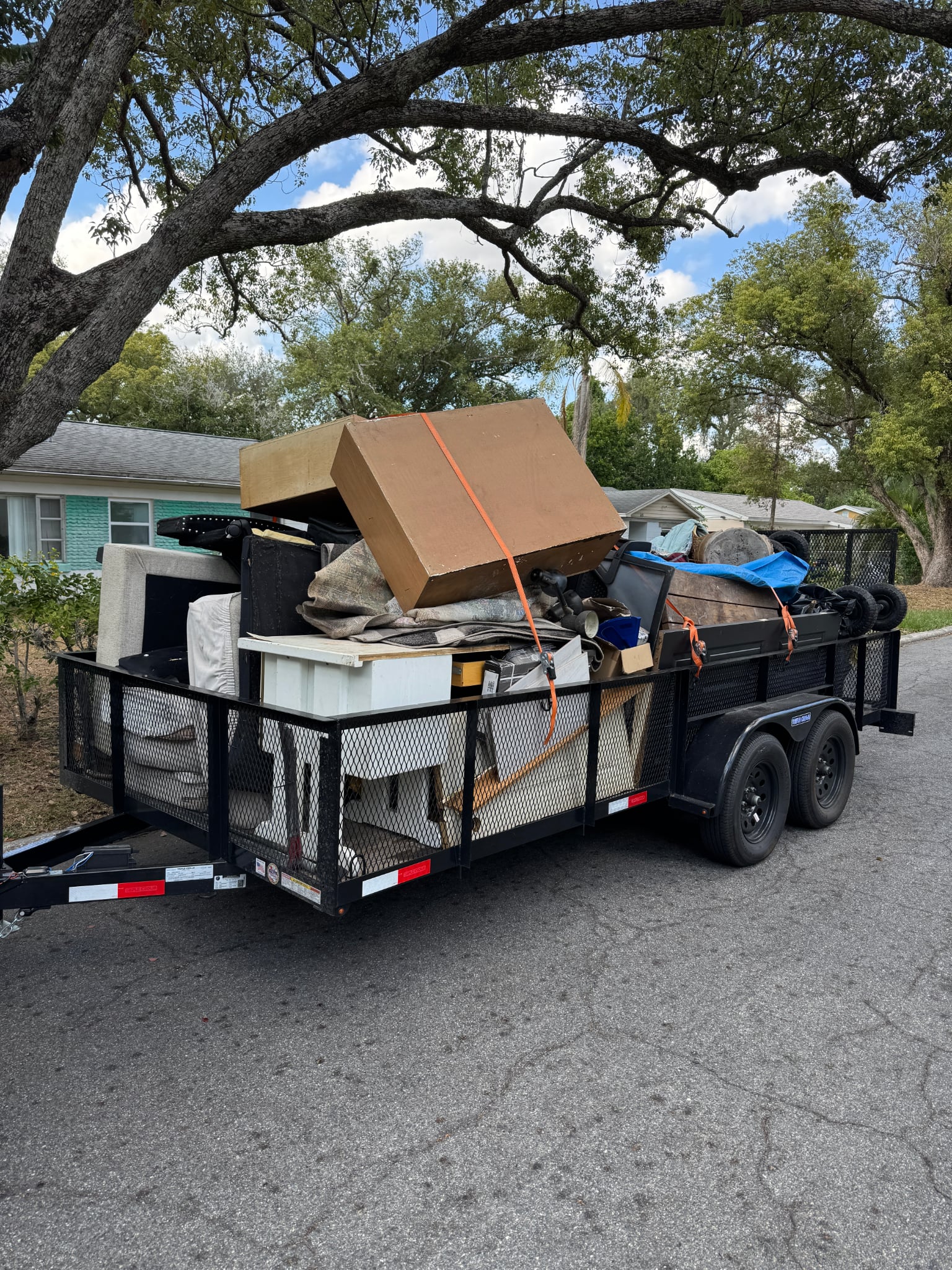 Trailer loaded with furniture and household items for removal in Lakeland