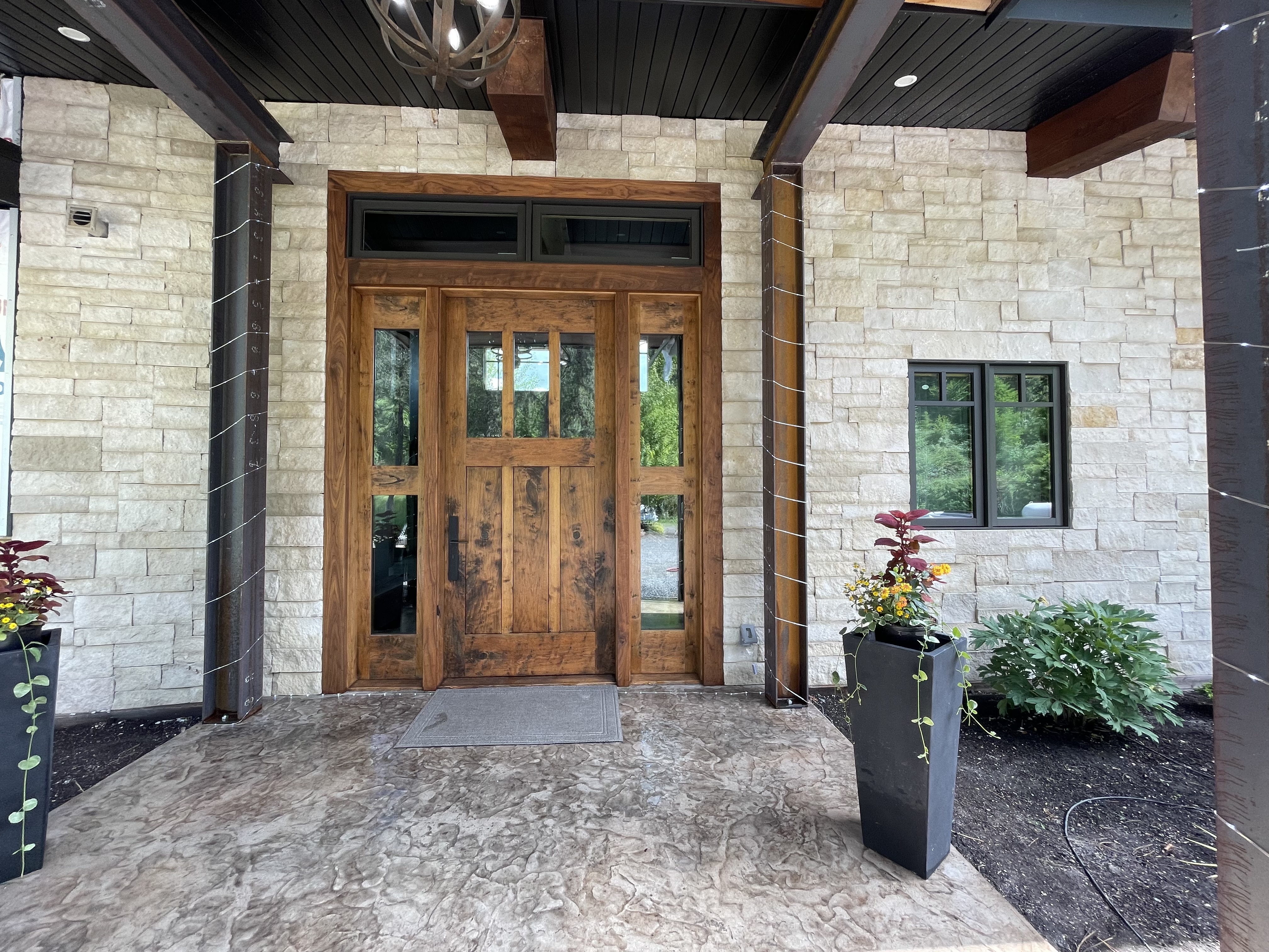 Custom stone exterior and flatwork entrance