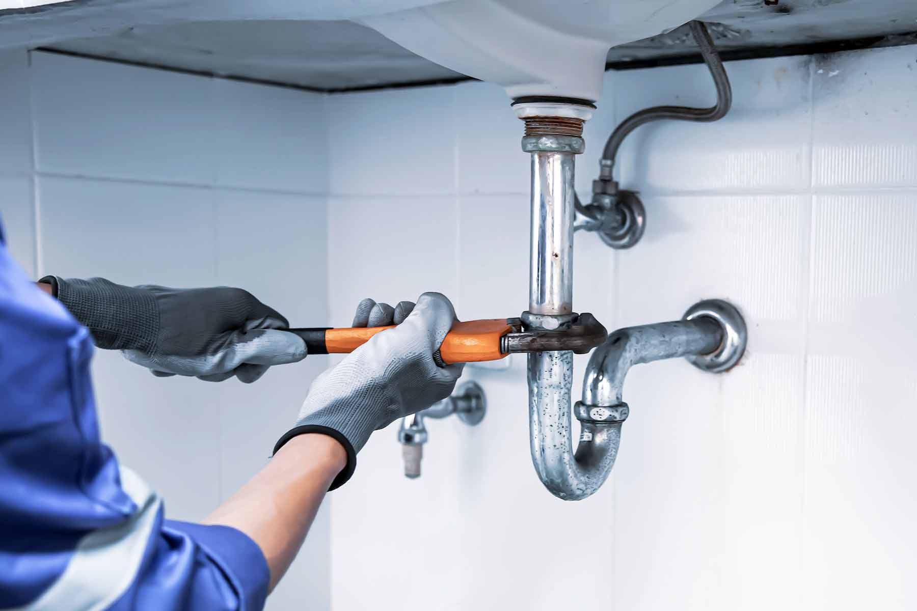 Plumber clearing a drain