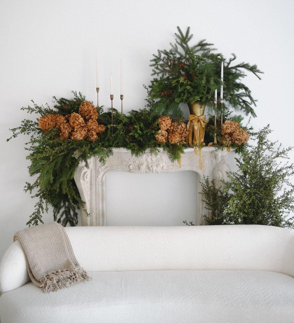 Sculptural mantel greenery and dried hydrangeas for a holiday gathering