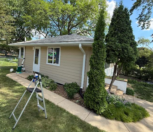 LP SmartSide Siding Installation After - Completed tan siding with new gutters - Columbia Heights MN