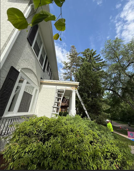 EPDM Flat Roof Installation - Minneapolis MN - crew working on historic home exterior