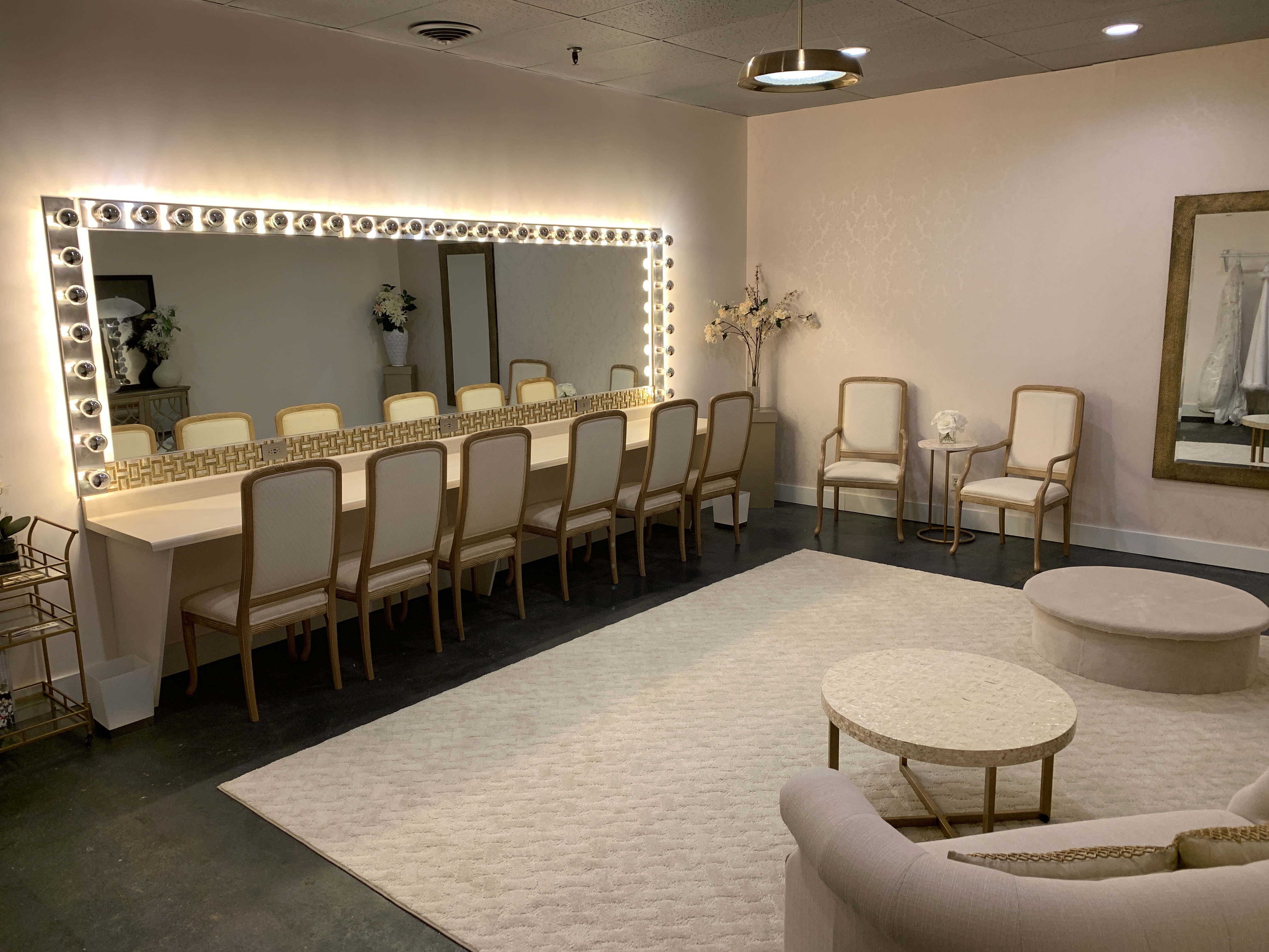 Luxurious bridal suite showing large vanity mirror and seating area at Suite One Eleven Event Venue