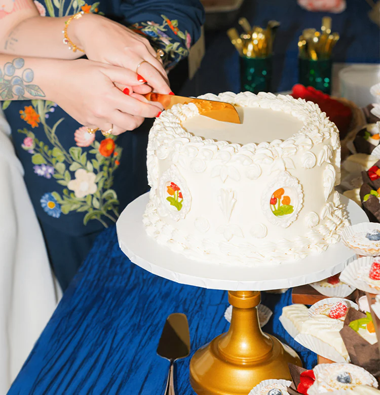 Beautiful custom wedding cake with hand-painted floral details at Suite One Eleven Event Venue
