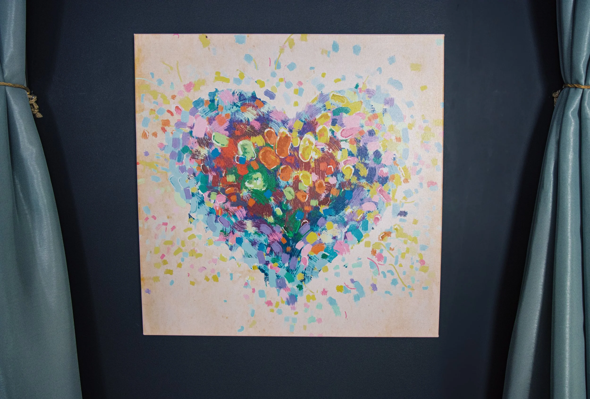 Colorful painted heart on canvas