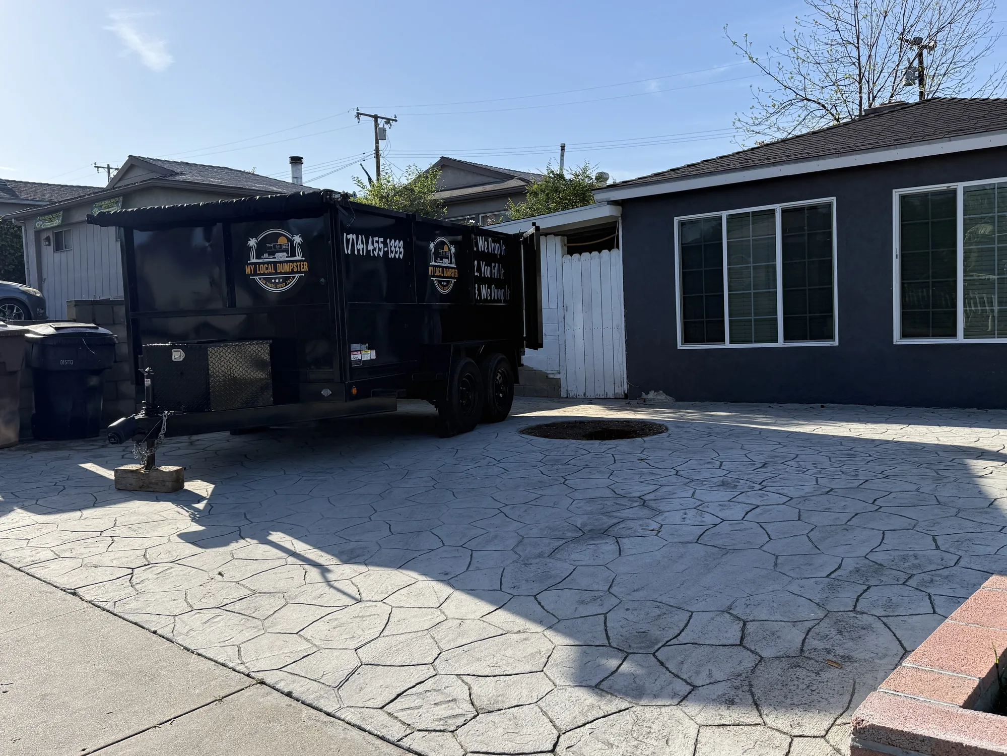 Dumpster rental positioned for side-gate access on a residential property