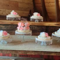 Floral cake displays on wooden stands
