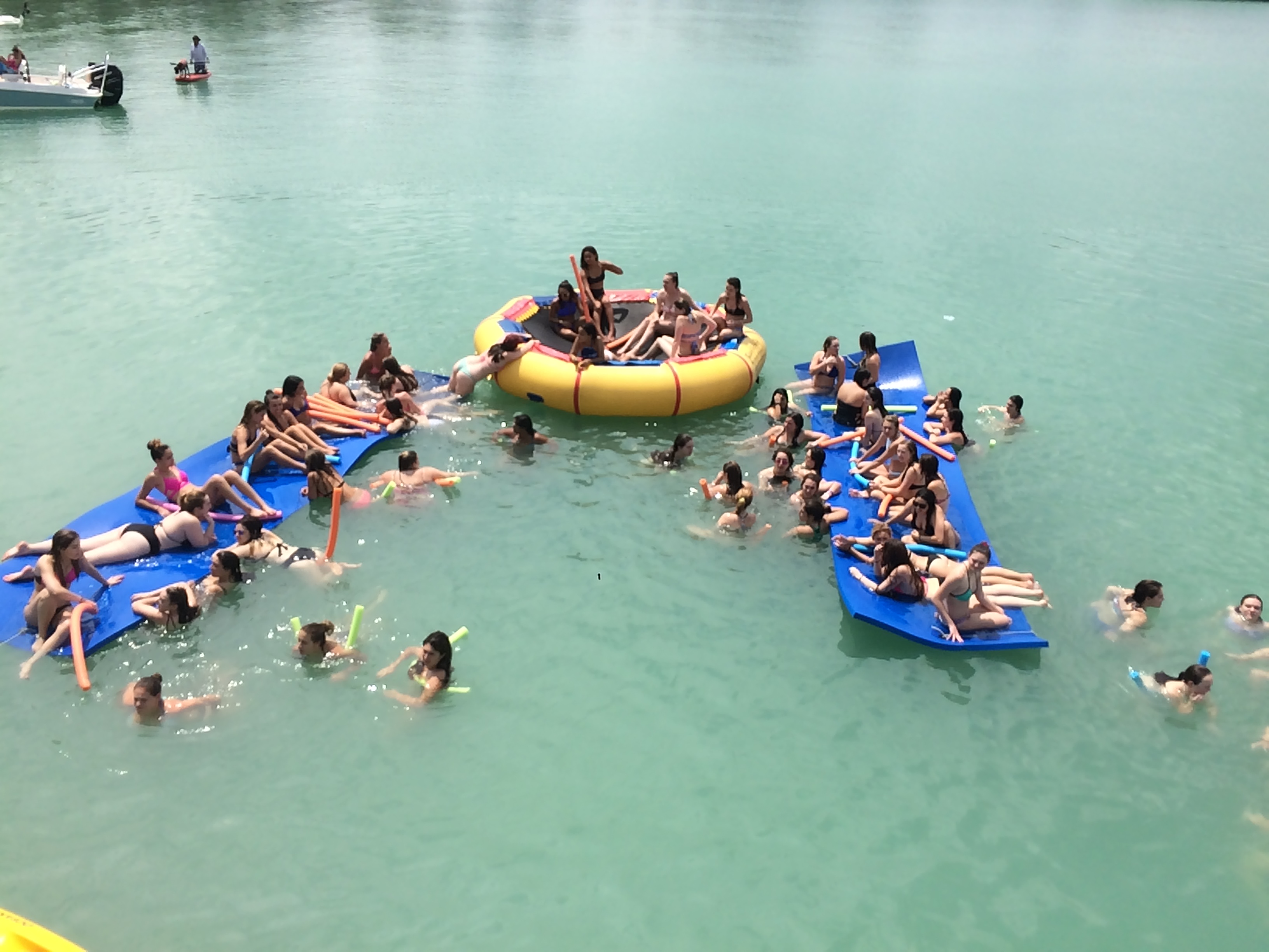 Guests enjoying floating mats and water toys