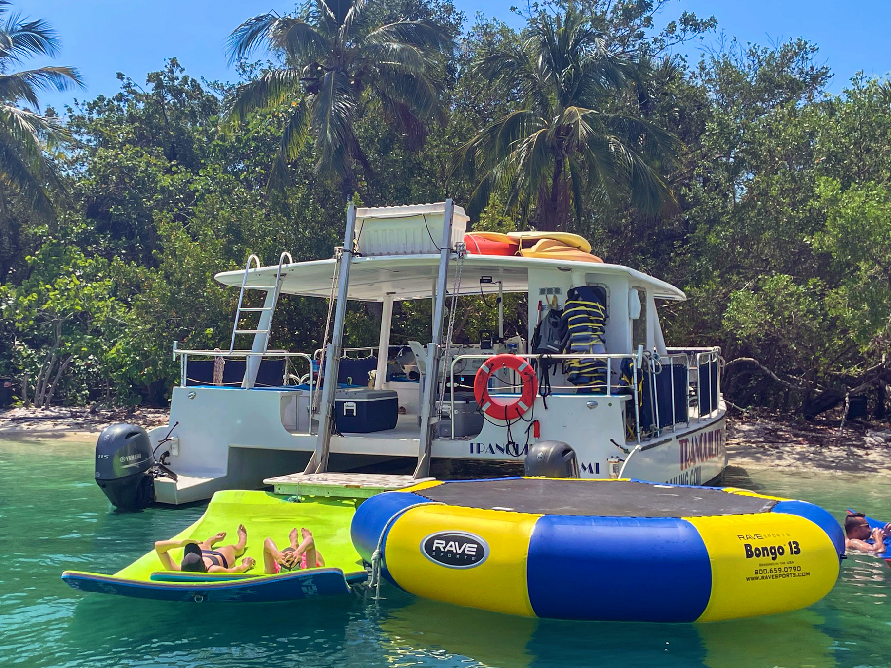 Tranquility anchored with guests relaxing on water toys