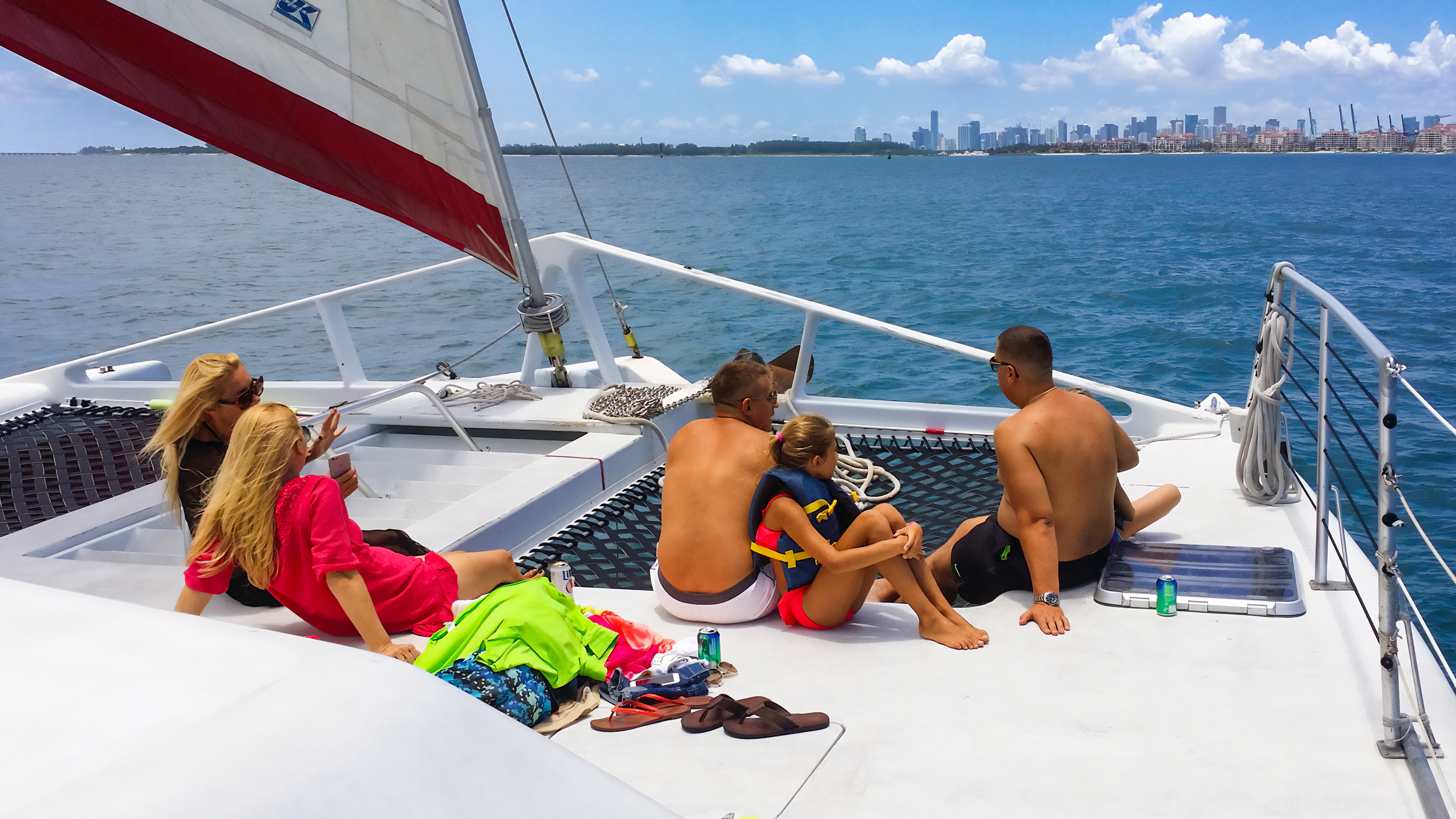 Guests relaxing on the bow nets of the catamaran