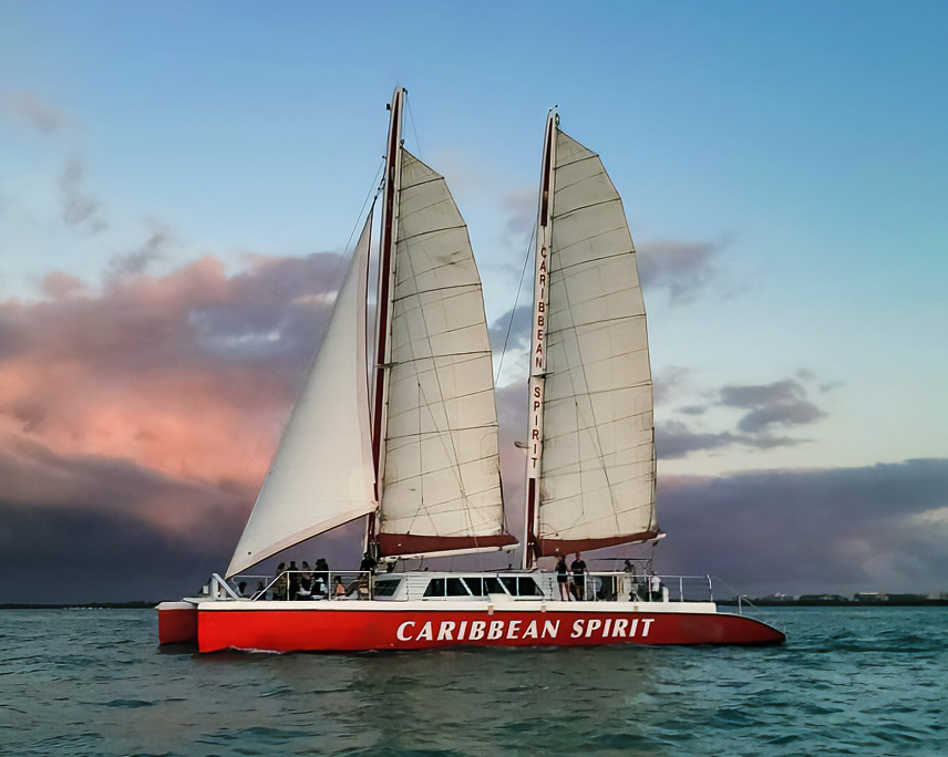 Caribbean Spirit sailing at sunset with sails up