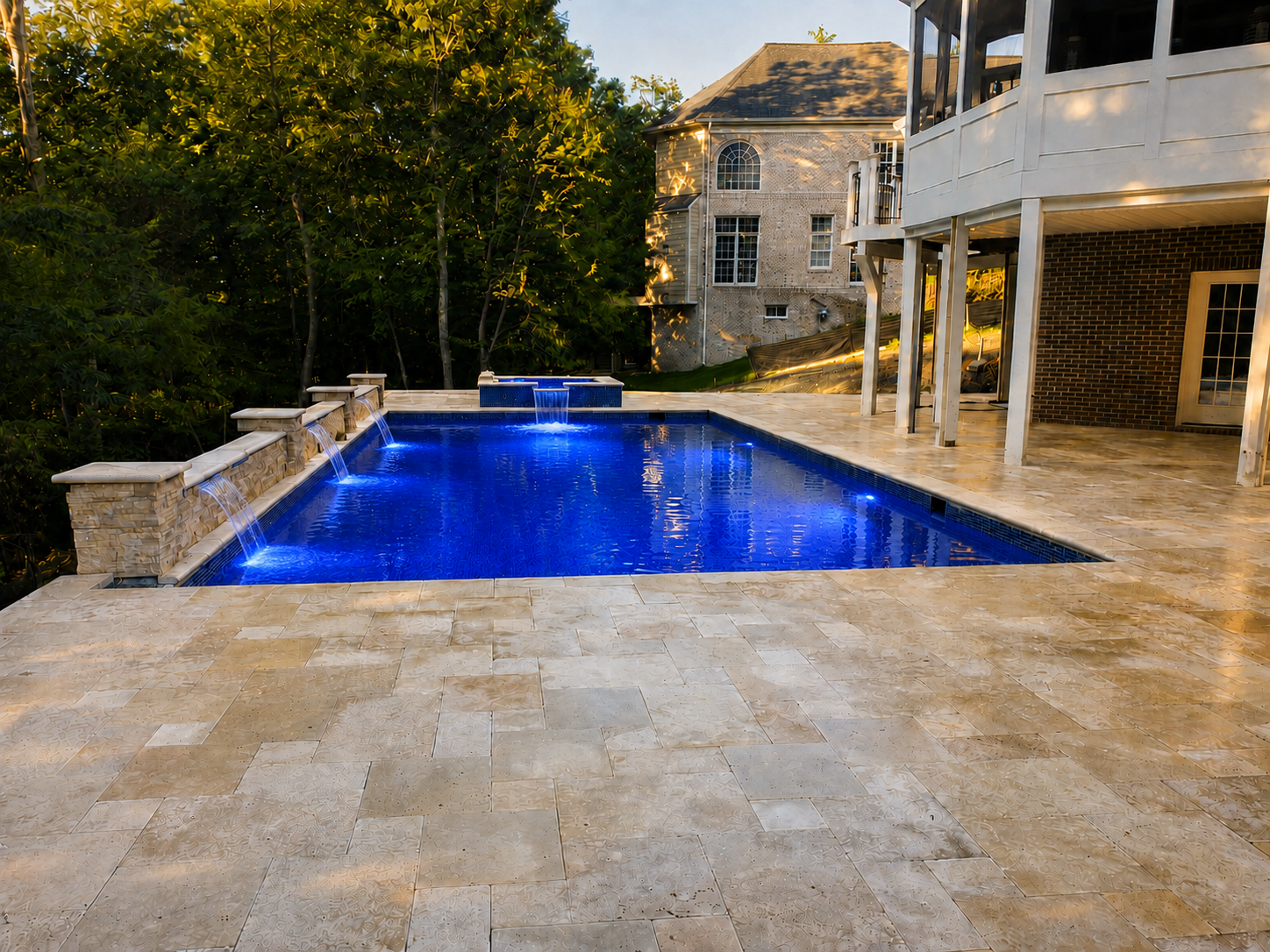 Completed luxury gunite pool renovation with raised spa and water features in Lansdowne Virginia