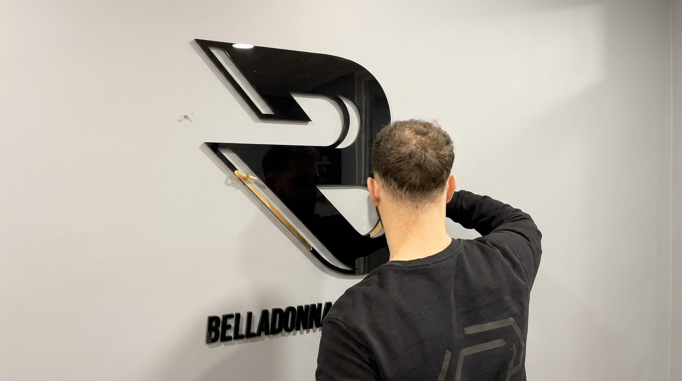 Installer fitting large 3D letter signage to a wall