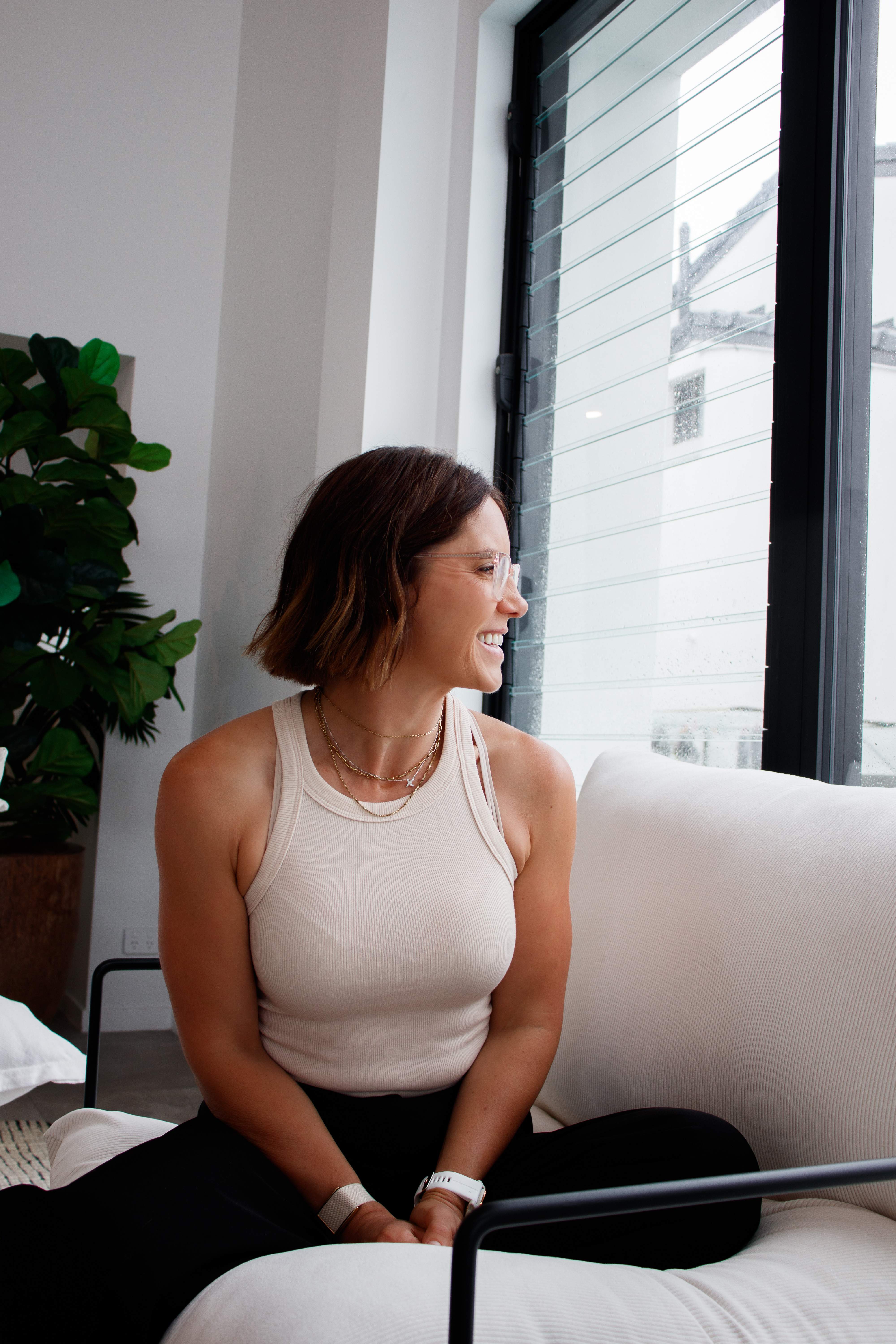 Carla smiling by the window