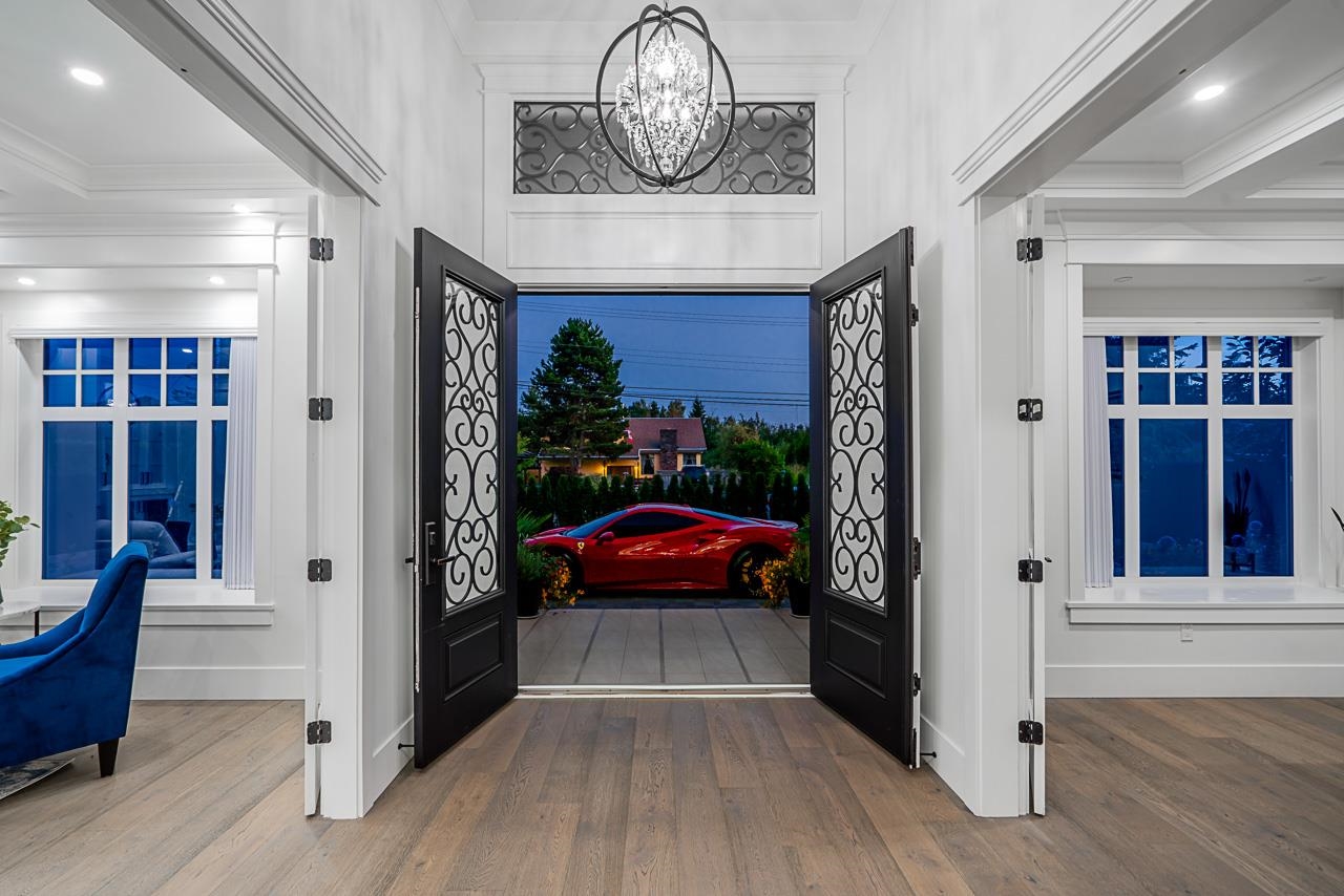 Luxury home entrance with red sports car