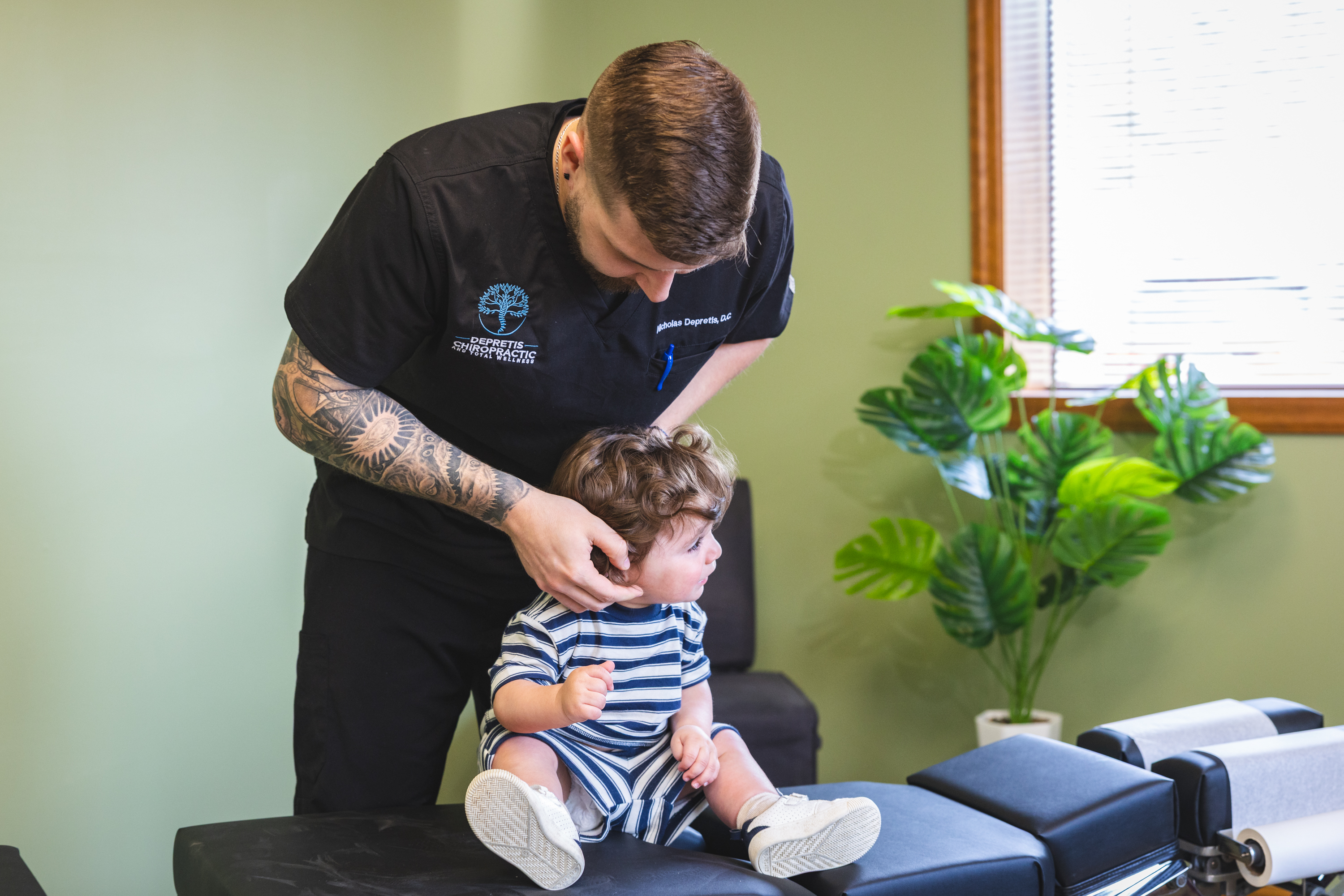 Chiropractor checking baby's neck