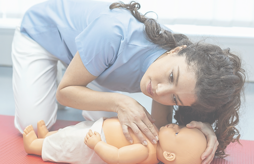 Instructor demonstrating infant CPR on a training doll