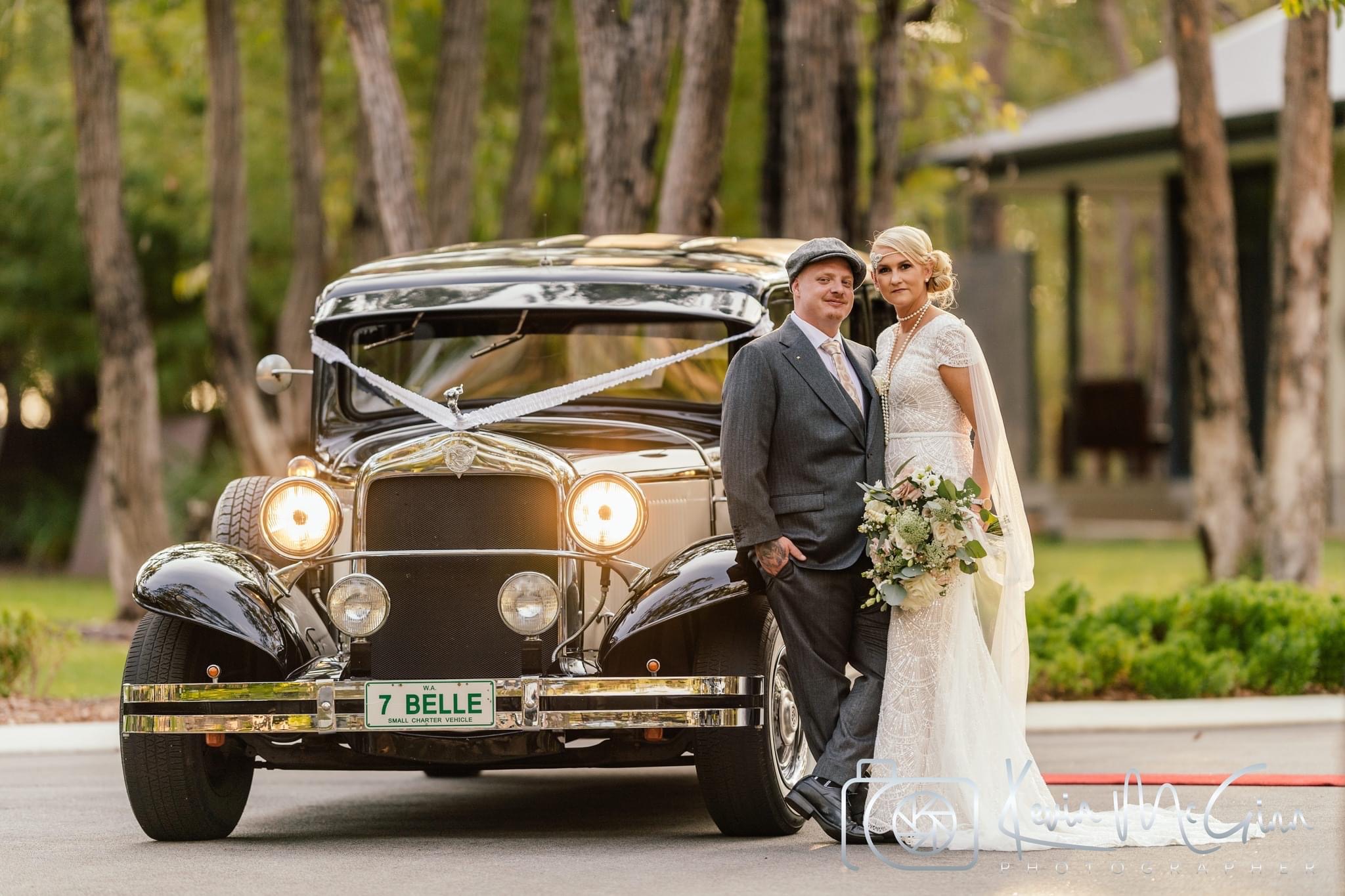 Beautiful bride and groom with vintage wedding car in Perth