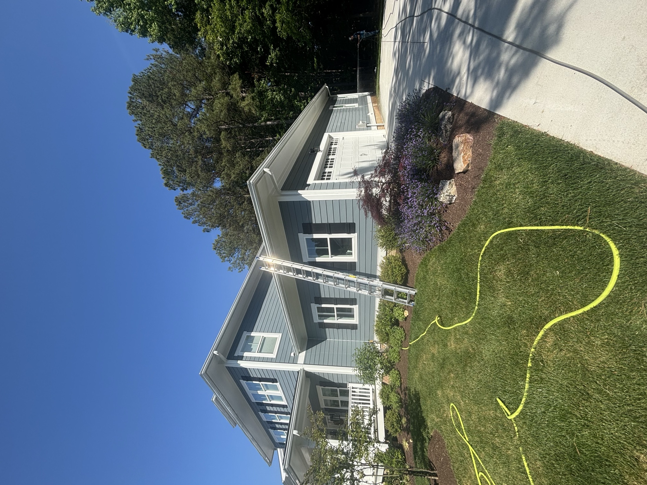 Gray coastal home with freshly soft washed siding and metal roof in Easton MD on Maryland's Eastern Shore