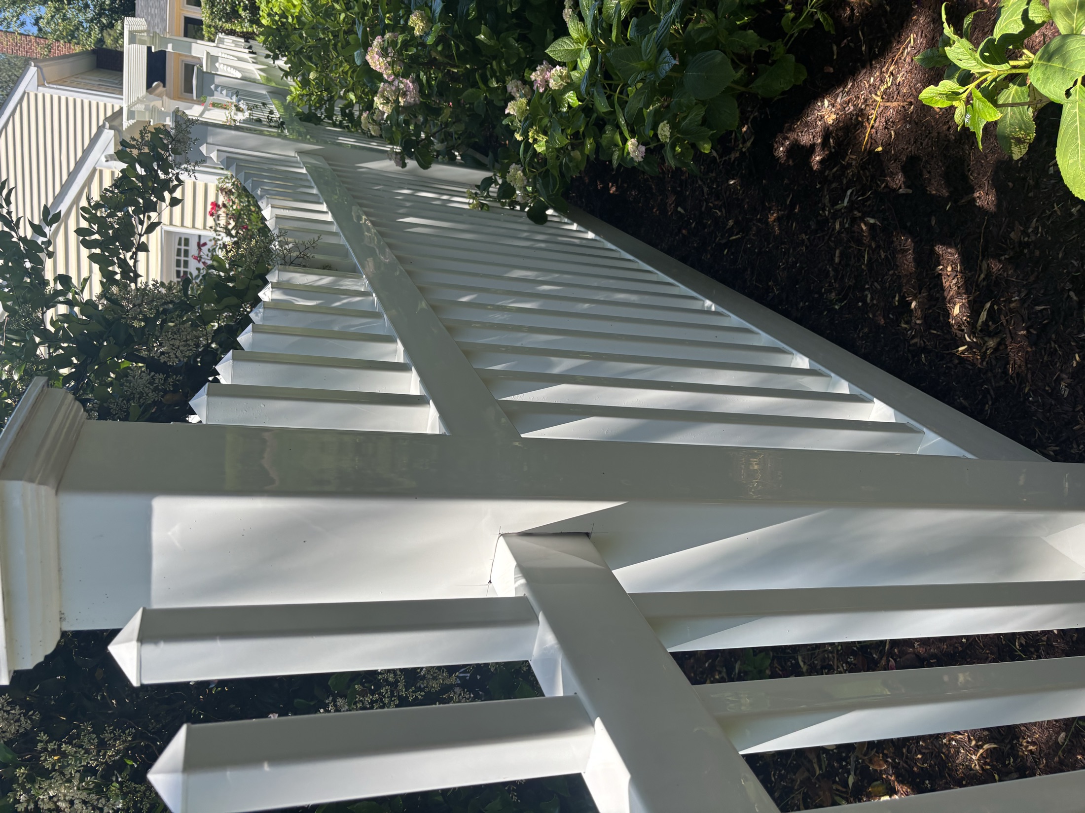 Soft-washed white pergola and arbor restored to bright clean finish in Easton MD on the Eastern Shore