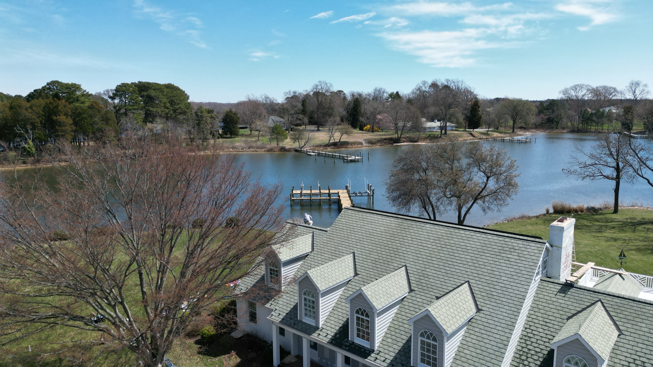 Aerial view of a soft-washed dormered shingle roof on a waterfront home in Easton MD on Maryland's Eastern Shore