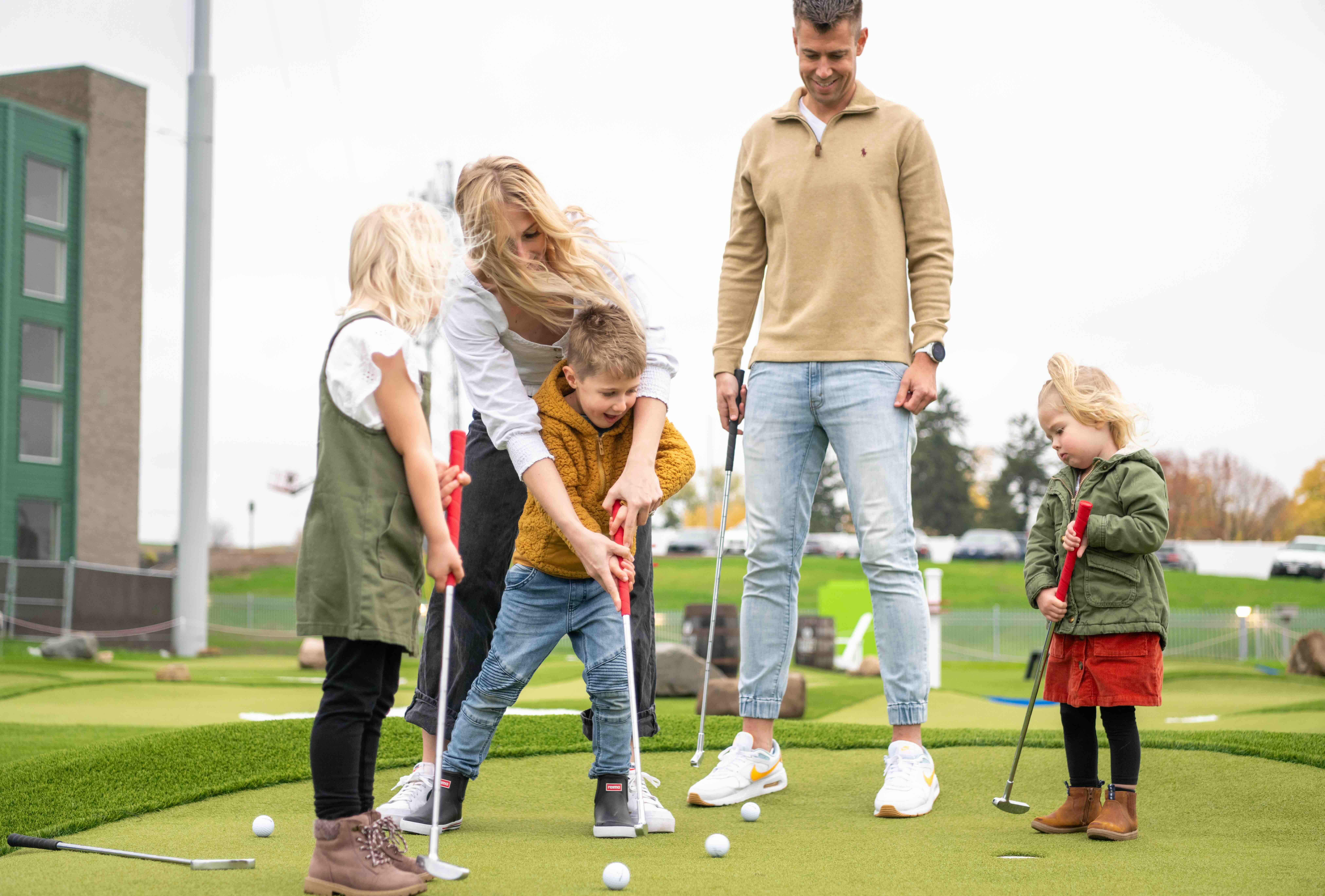Family playing golf