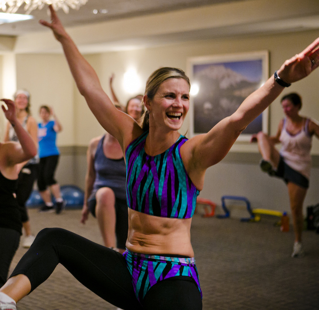 Pam coaching and smiling during a fitness workout