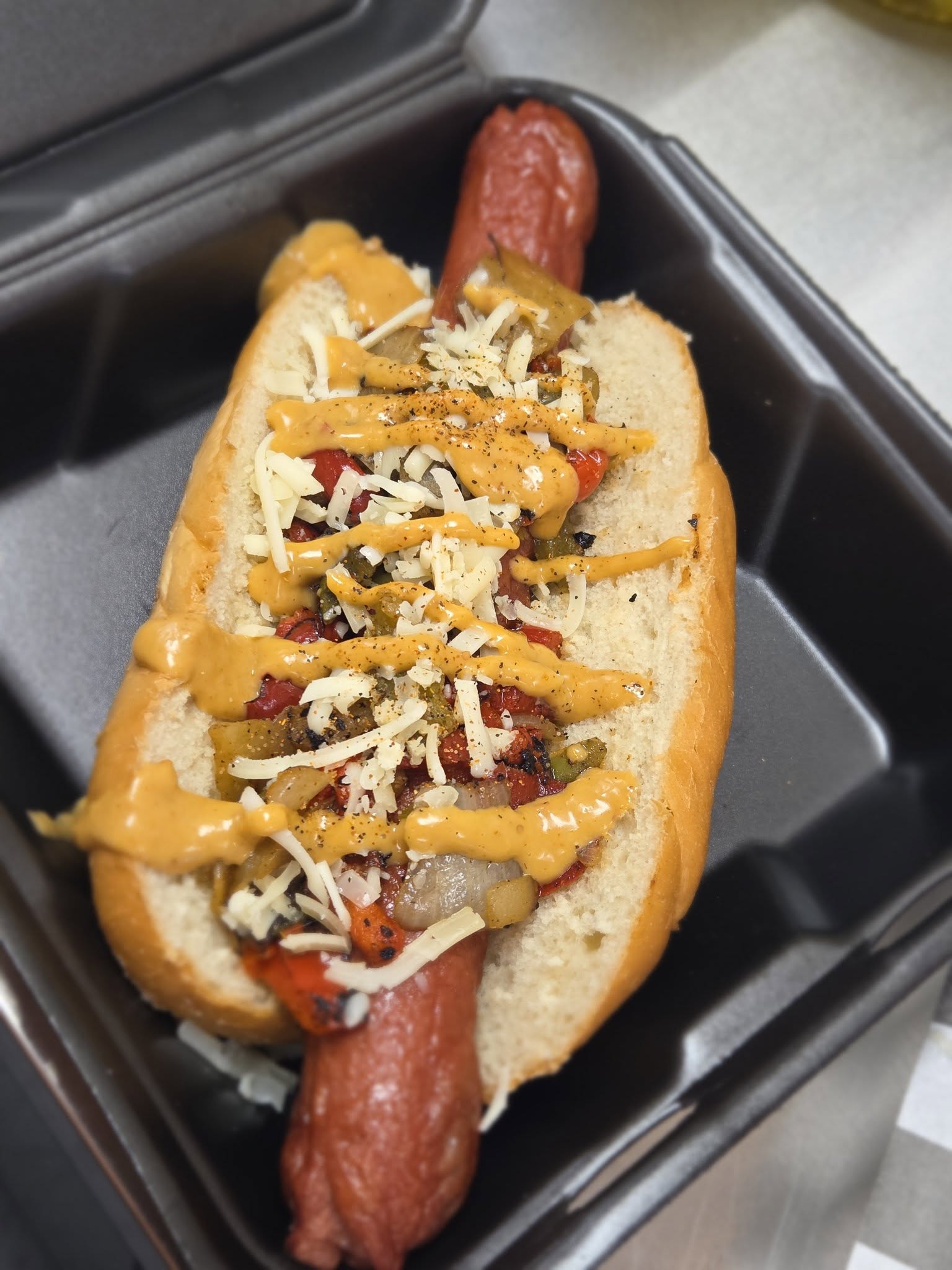Loaded hot dog with peppers and cheese