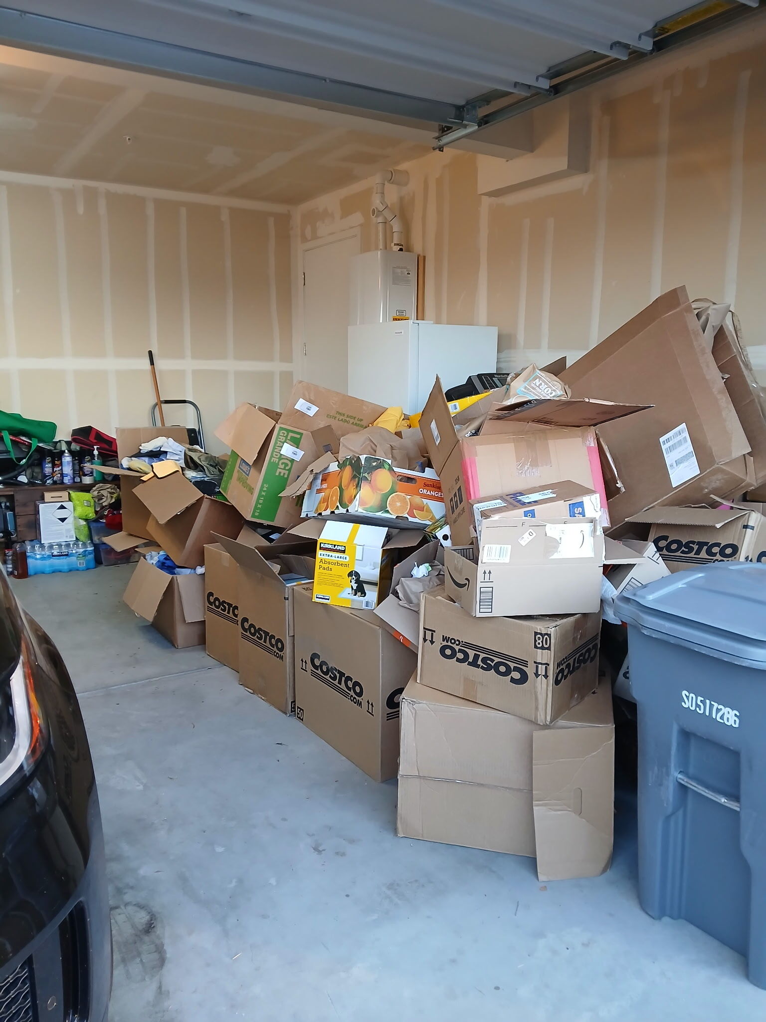 Before junk removal: cluttered two-car garage