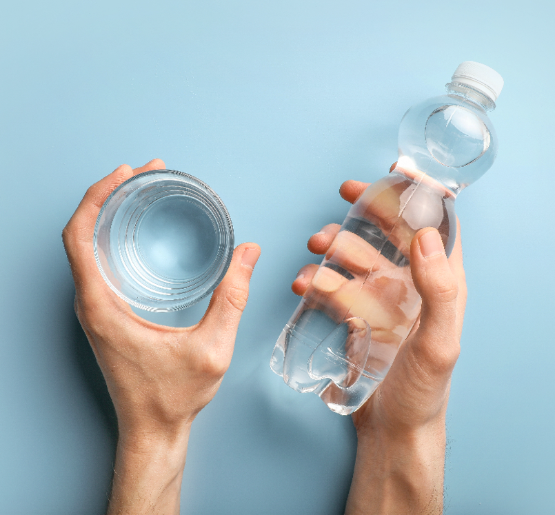 Clean glass of water and water bottle