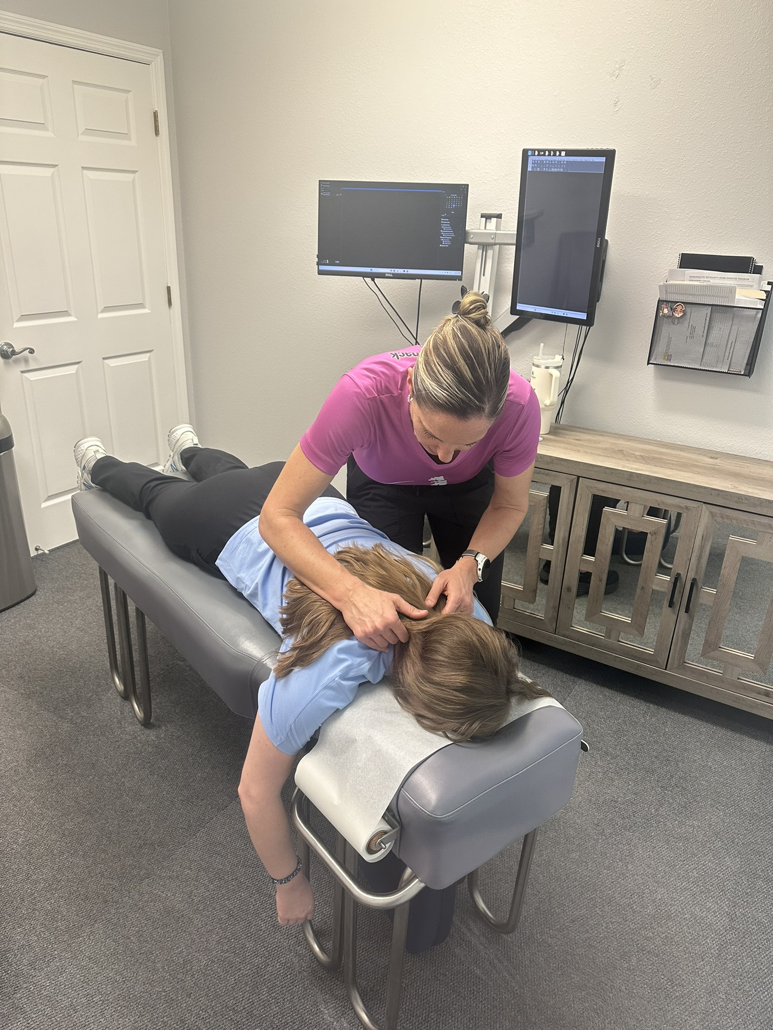 Dr. Heidi performing chiropractic neck adjustment in Lutz FL