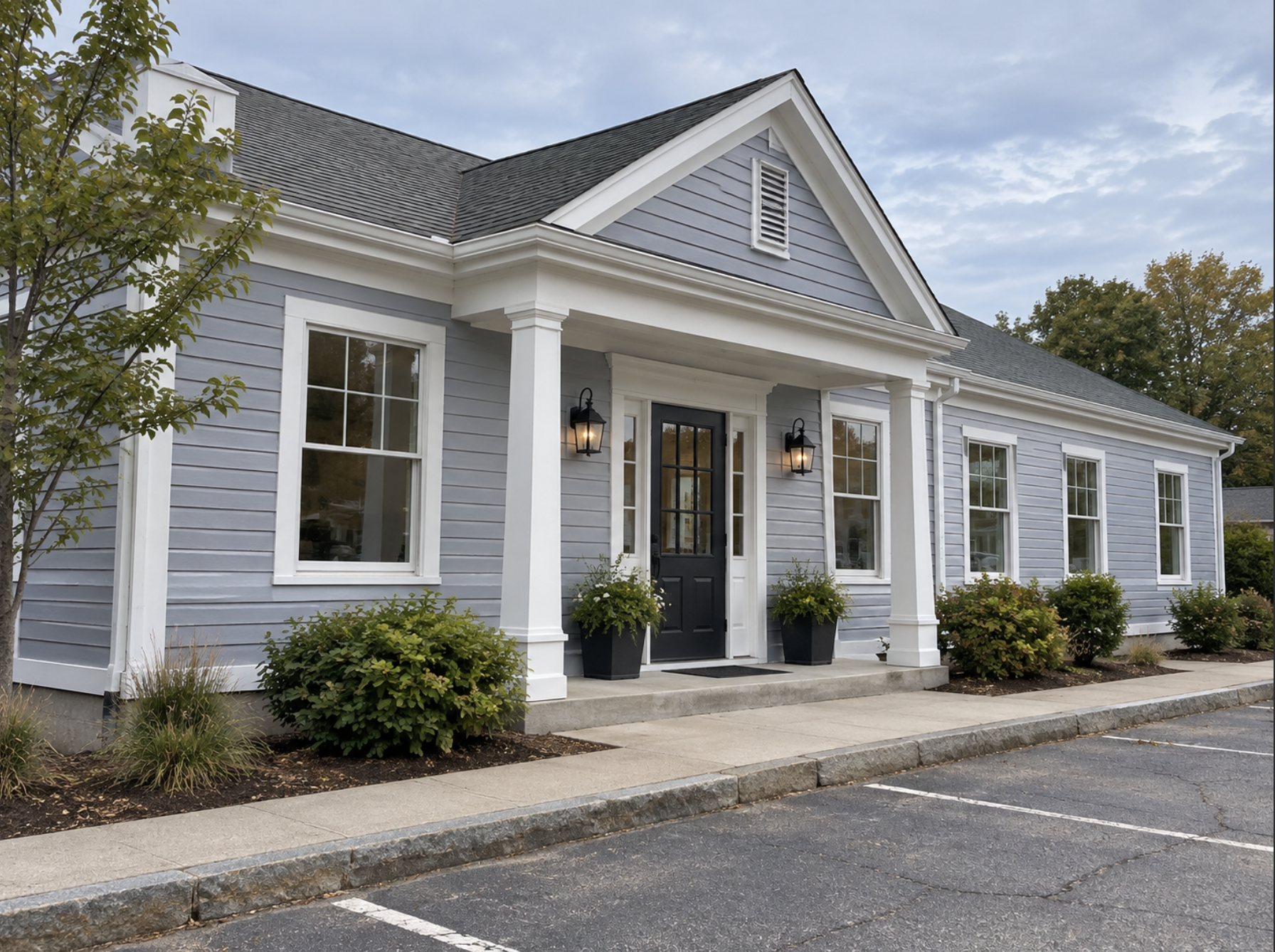 Completed commercial office exterior painting with gray siding and crisp white trim by Minute Men Painters