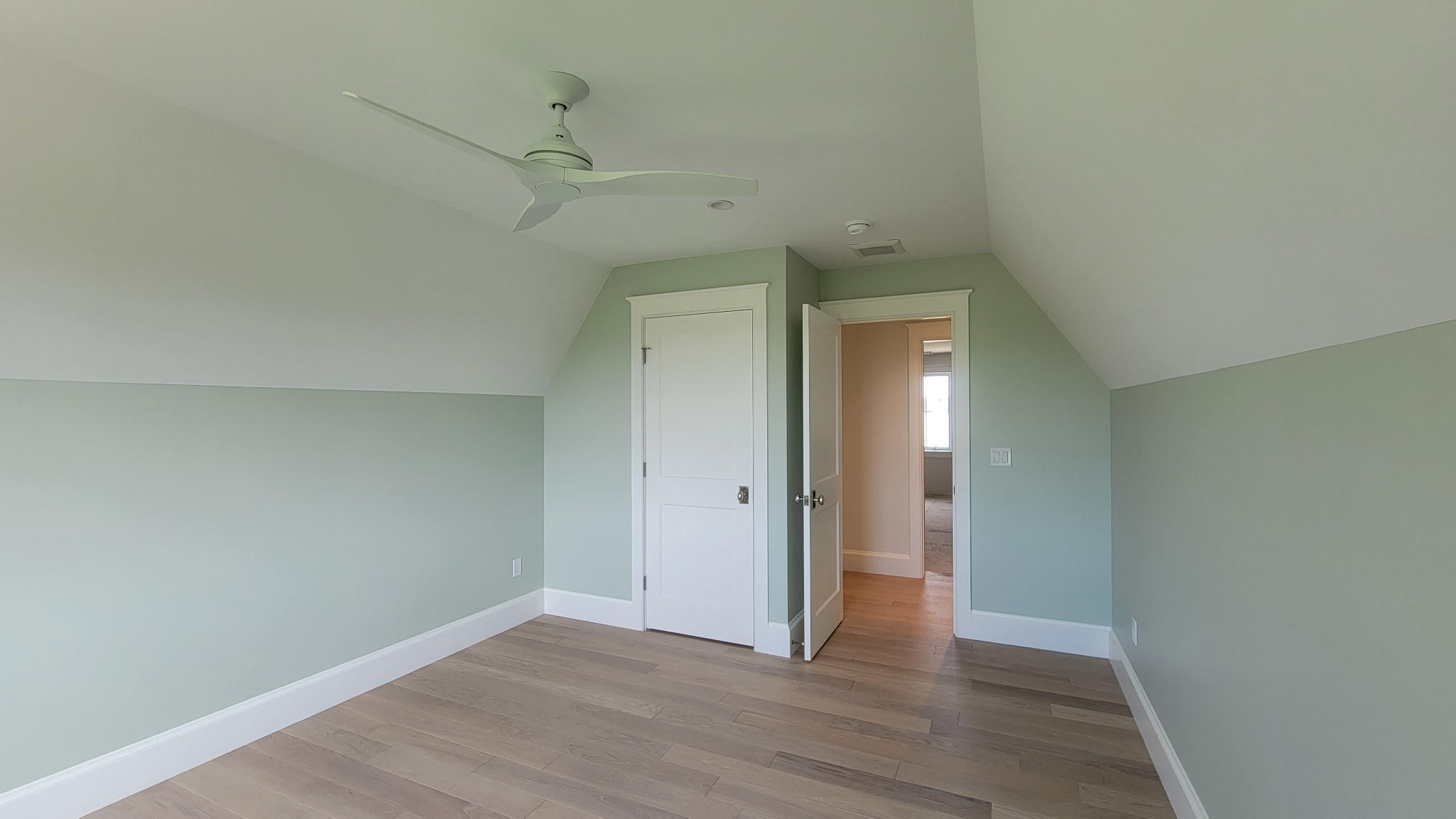 Whole-home interior painting with white paneled ceiling, staircase trim, and open living space by Minute Men Painters