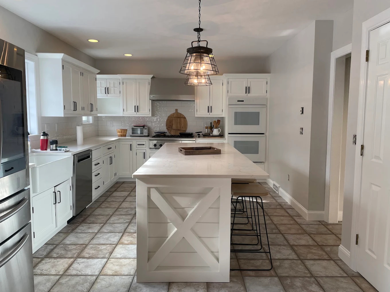 Modern kitchen cabinet update with crisp white satin finish by Minute Men Painters