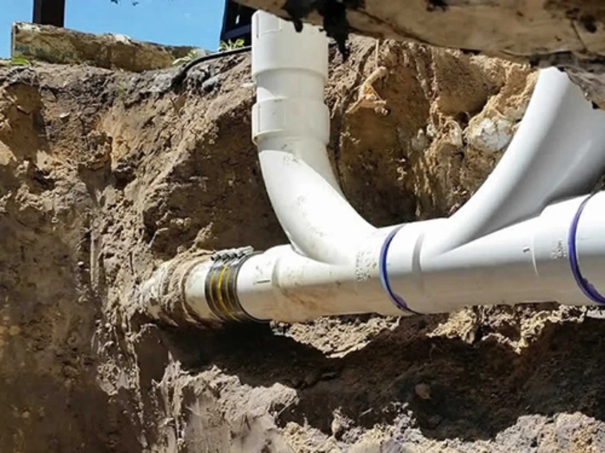 Exposed underground PVC sewer line pipe repair in Pearland TX