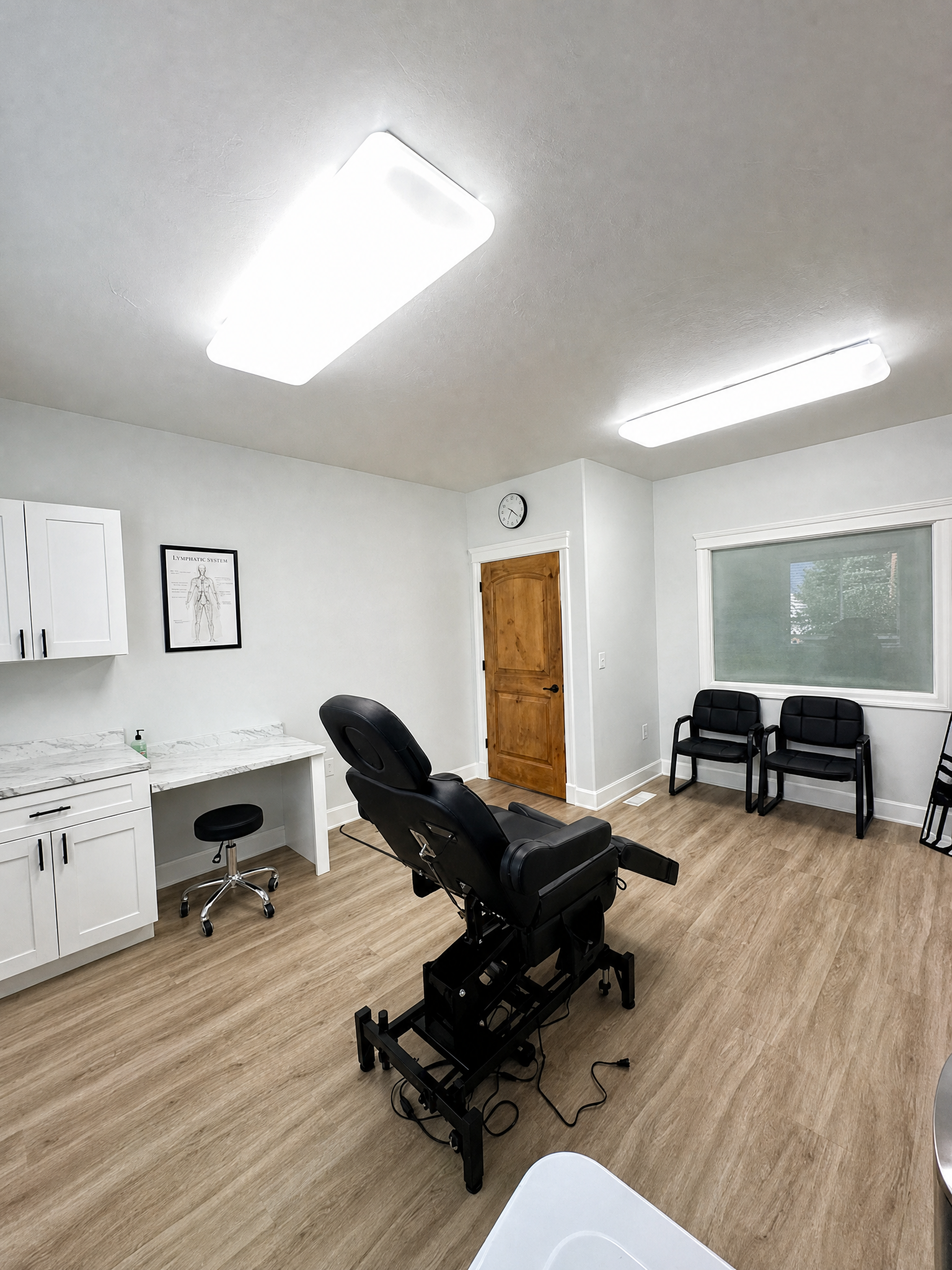 Lymphedema treatment room with specialized therapy table and lymphatic system diagram in American Fork, Utah clinic