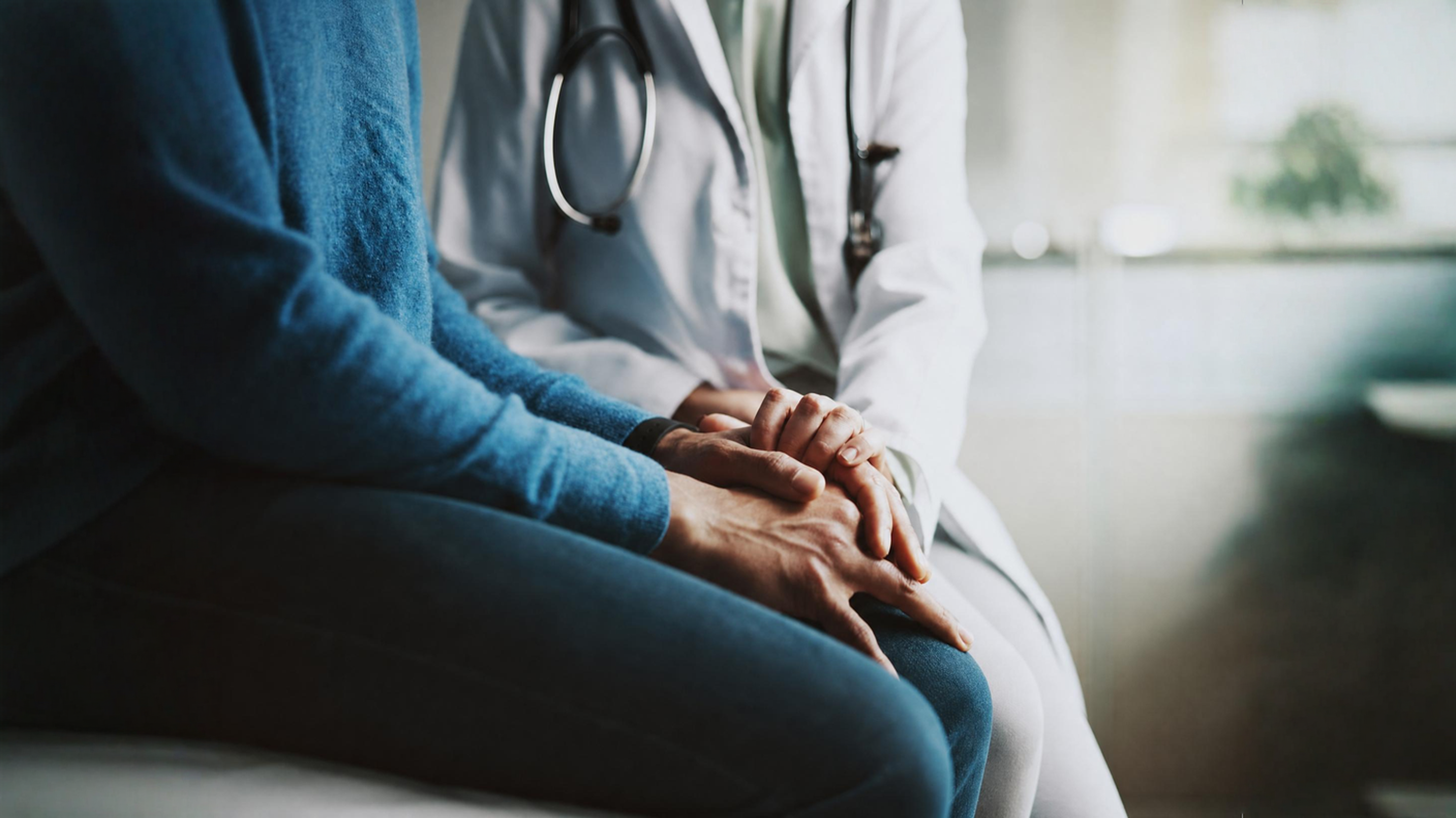 Doctor holding patient's hands