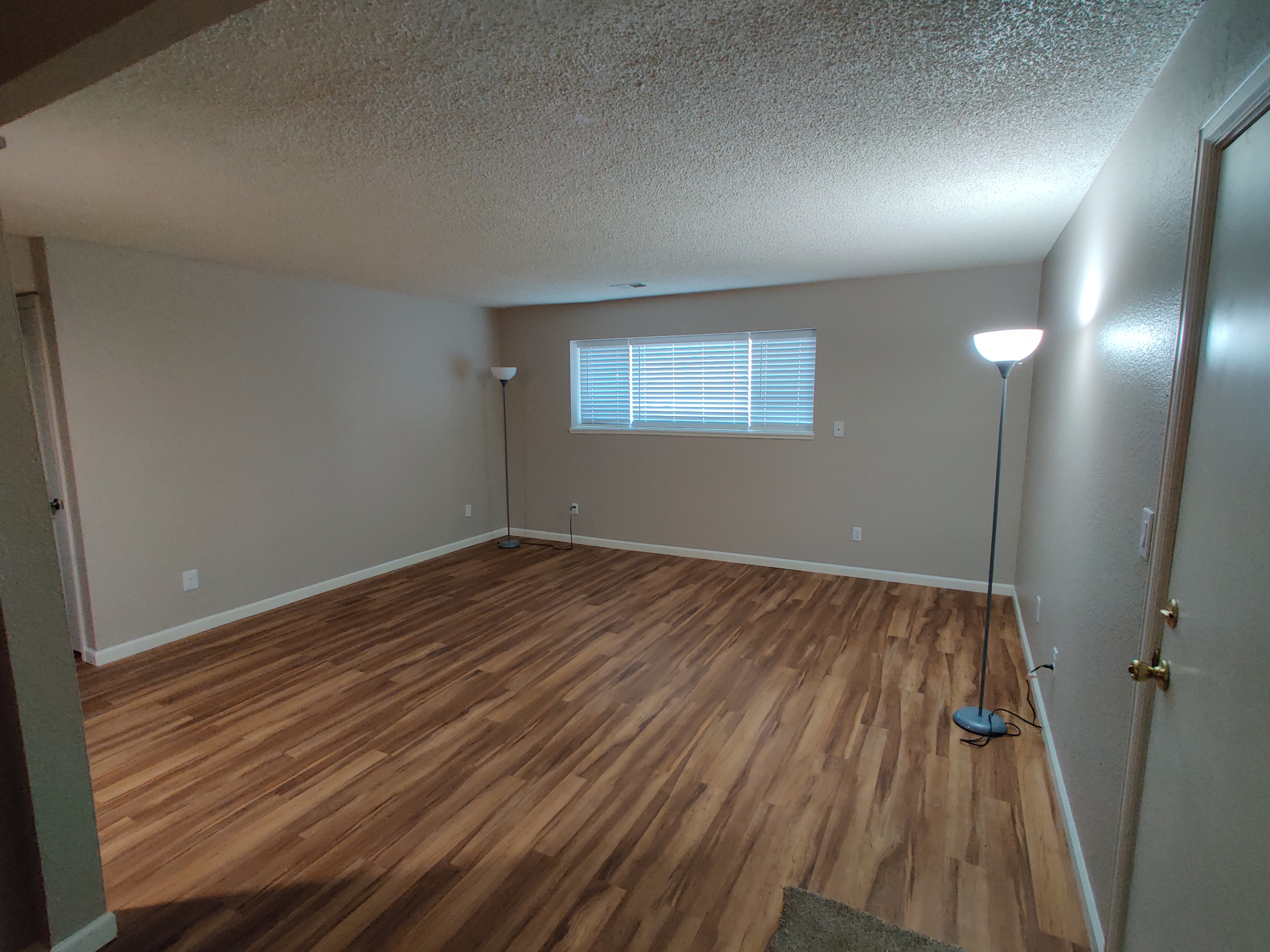 Rental unit make-ready work — clean empty room with hardwood floors