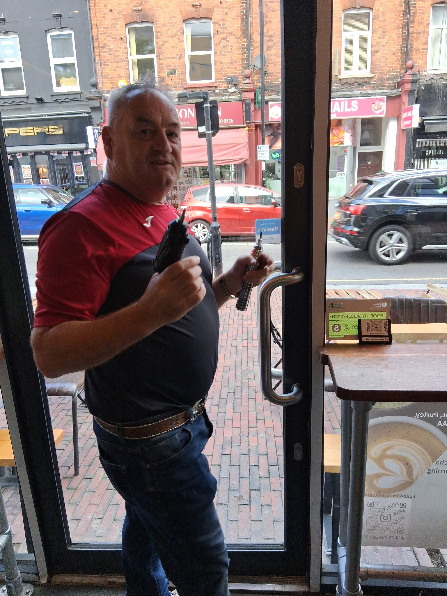 Purley locksmith, Duncan Wooley repairing a glass door at a local business
