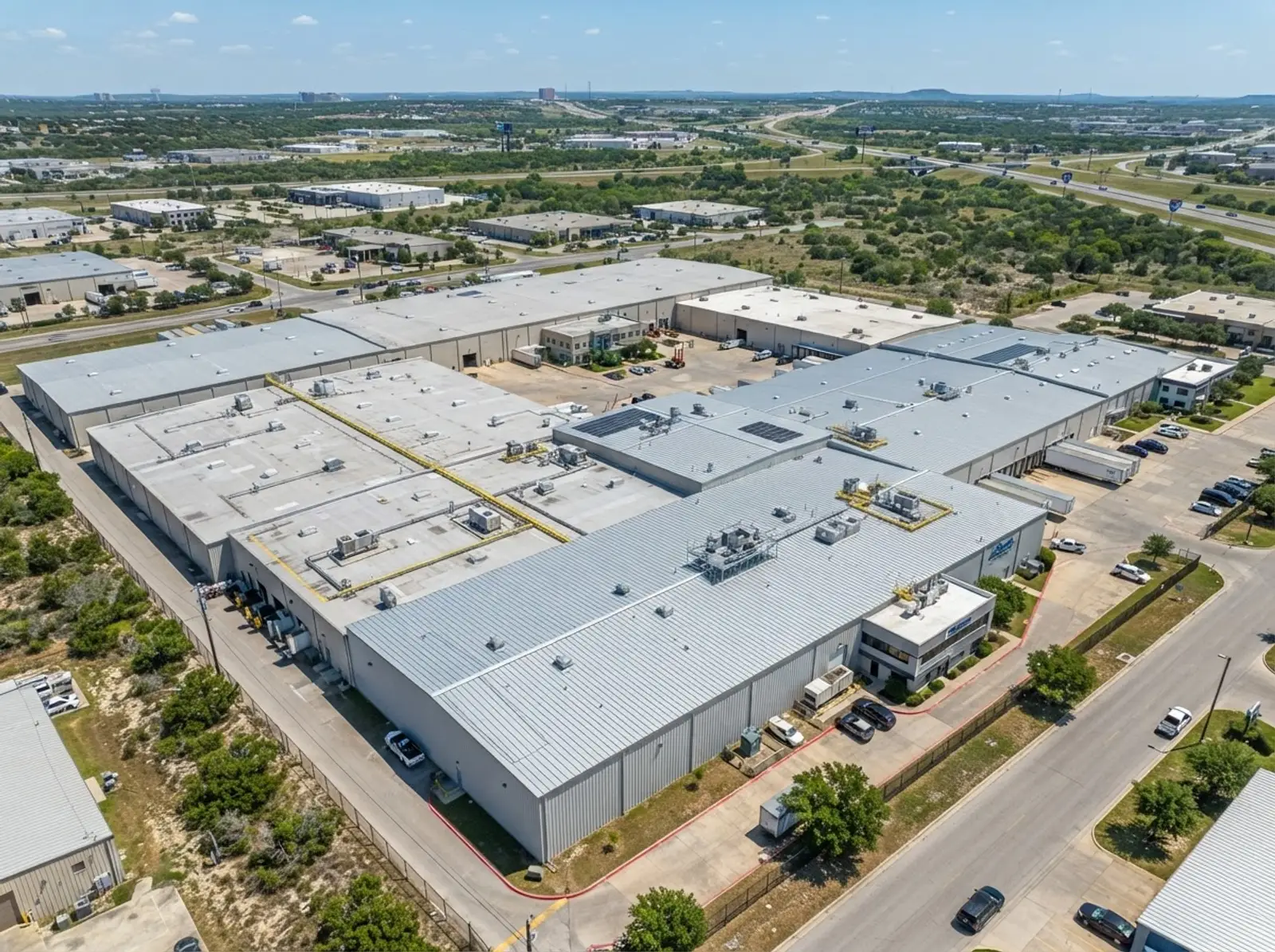 San Antonio industrial complex multi-roof drone inspection standing seam metal roof TPO sections commercial facility aerial monitoring Central Texas