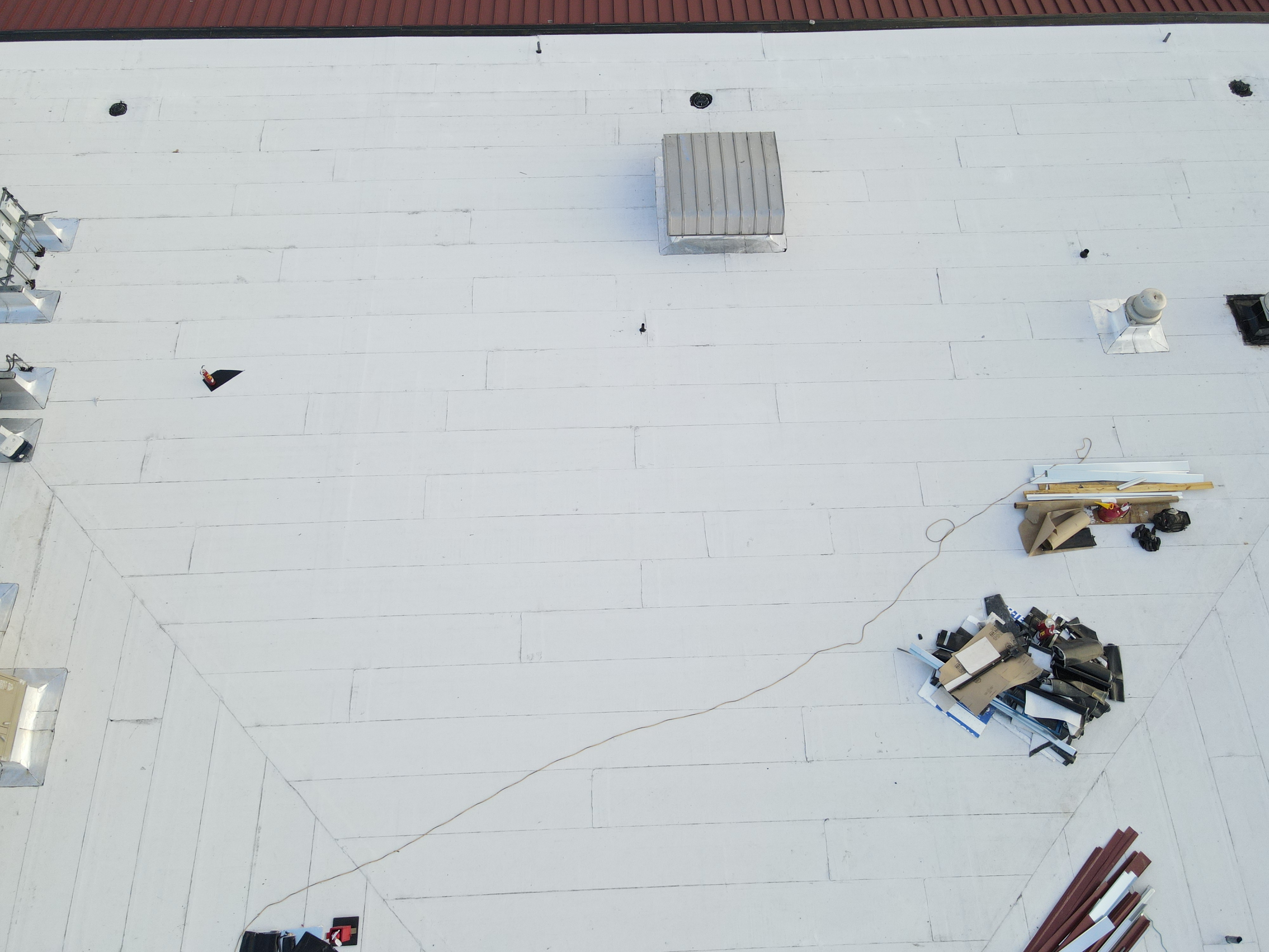 Commercial drone roof inspection San Antonio white TPO flat roof membrane HVAC units debris assessment Bexar County commercial property aerial survey