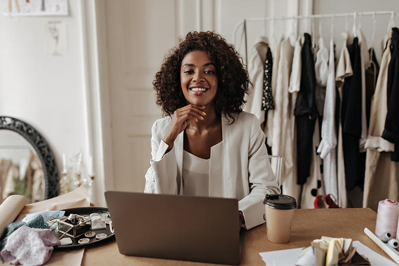 Fashion boutique owner managing marketing with ourCMO AI strategist